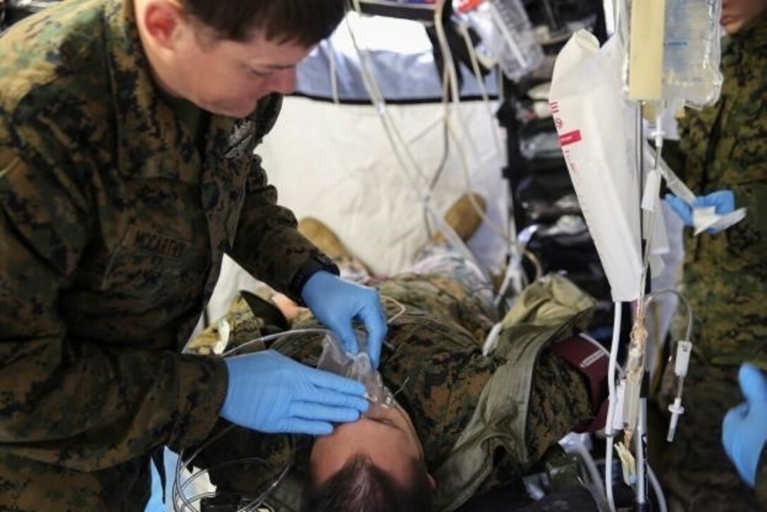 Petty Officer 2nd Class Derek McCarthy, a corpsman with 2nd Medical Battalion, treats a role-player for injuries in preparation for their upcoming multinational exercise, Cold Response 16.1, in Norway.at Camp Lejeune, N.C, Jan. 28, 2016.  The corpsmen treated injuries they will encounter in the cold weather climate they will experience in Norway.  (U.S. Marine Corps photo by Cpl. Michael Dye/Released)