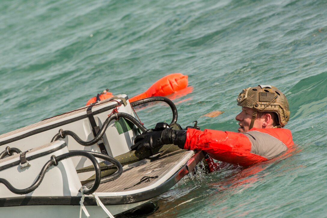 An Air Force pararescueman climbs aboard a recovery boat during Operation Jesse Relief, a joint search and rescue exercise in Key West, Fla., Jan. 25, 2016. Missouri Air National Guard photo by Senior Airman Sheldon Thompson