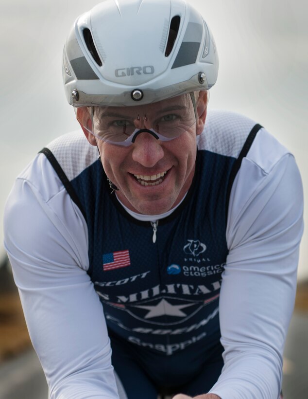 Senior Master Sgt. Jason Chiasson, the 39th Communications Squadron production superintendent, cycles past the fightline at Incirlik Air Base, Turkey, Dec. 10, 2015. Chiasson is a member of the Air Force Cycling Team and regularly rides multiple laps around the flightline to train for longer endurance rides. (U.S. Air Force photo/Senior Airman Krystal Ardrey)