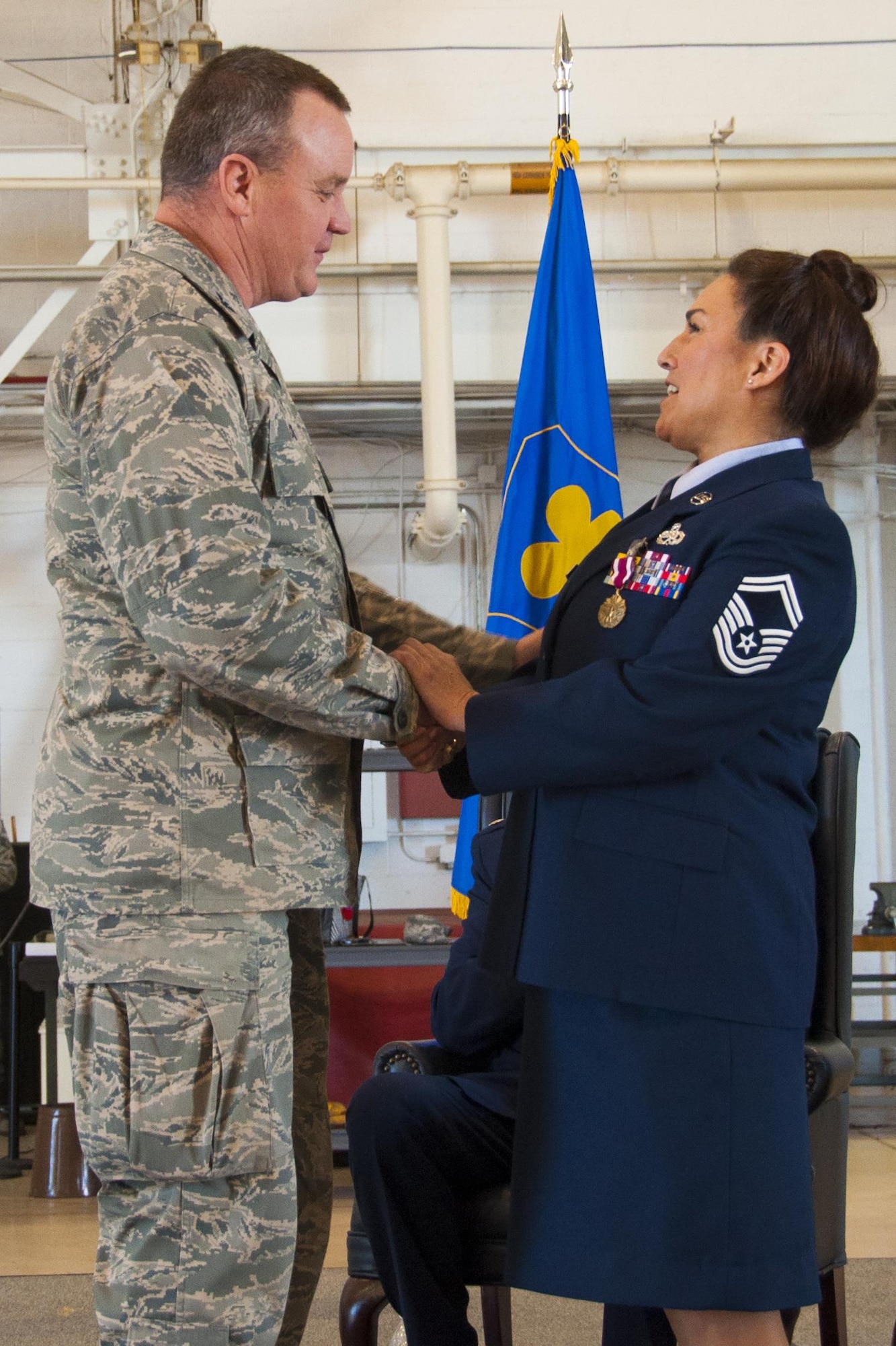 U.S. Air Force Col. Bruce Cox, 307th Bomb Wing commander, presents Senior Master Sgt. Mary Wagner with the commander’s coin at Barksdale Air Force Base, La., Jan. 30, 2016.   He made the presentation as part of Wagner's retirement ceremony.   Wagner served for a total of 38 years in the Air Force and Air Force Reserve. She was assigned to the 707th Maintenance Squadron as the aircraft maintenance superintendent.  (U.S. Air Force photo by Tech. Sgt. Ted Daigle/released)