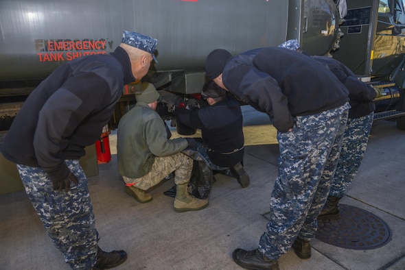 Members from Naval Air Facility Atsugi observe as personnel take JP-8 fuel samples from an R-11 refueling trucks at Yokota Air Base, Japan, Jan. 26, 2016. The training allowed members to be prepared to support Navy aircraft at Andersen Air Force Base, Guam, during exercise Cope North. (U.S. Air Force photo/Senior Airman David Owsianka)