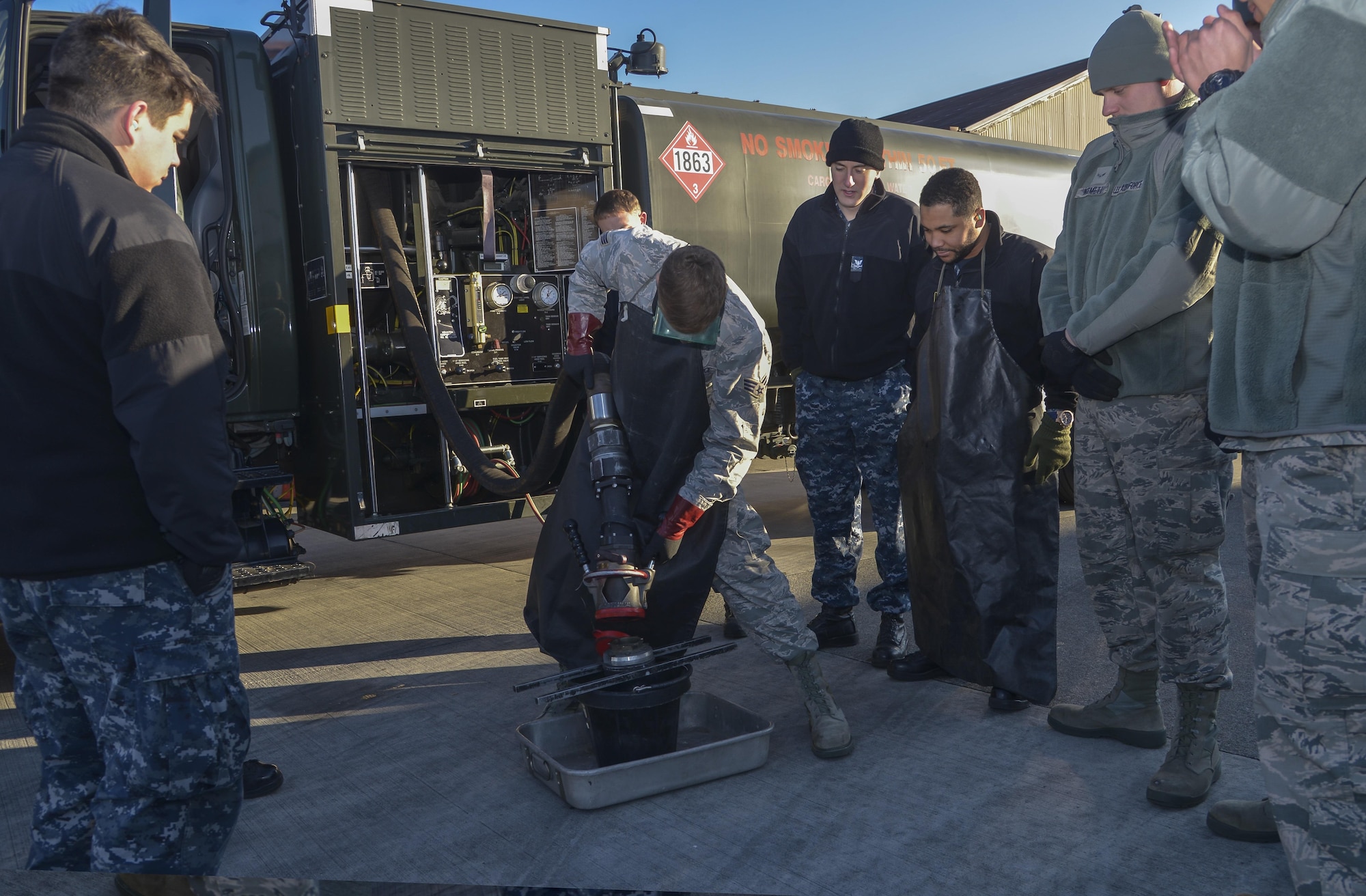 Senior Airman Tyler Sims, a 374th Logistics Readiness Squadron Fuels Management Flight fuels training supervisor, shows Sailors from Naval Air Facility Atsugi how to properly remove a fuel hose nozzle at Yokota Air Base, Japan, Jan. 26, 2016. The training allowed members to be prepared to support U.S. Navy aircraft at Andersen Air Force Base, Guam, during exercise Cope North. (U.S. Air Force photo/Senior Airman David Owsianka)