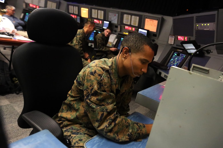 Cpl. Justin McDaniel assists a pilot over the radio with navigation at Marine Corps Air Station Cherry Point, N.C., Dec. 3, 2015. McDaniel was presented the Navy and Marine Corps Achievement Medal for his quick and precise problem solving skills that led to the safe landing of an AV-8B Harrier that had experienced navigational equipment failure. His actions on Dec. 1, 2015, were the product of McDaniel’s extensive training and well-earned confidence in his own skills as an air traffic controller. (U.S. Marine Corps Photo By Cpl. N.W. Huertas/Released) 
