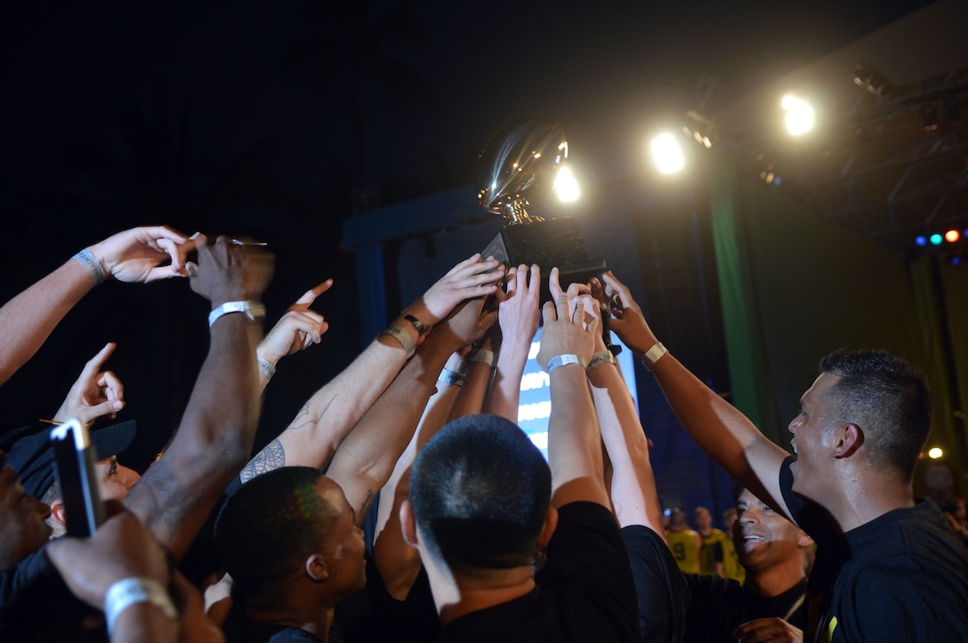 Members of Team Army raise their trophy after winning the 2016 Pro Bowl Military Challenge at Queen's Beach in Honolulu, Jan. 29, 2016. Army photo by Staff Sgt. Armando R. Limon