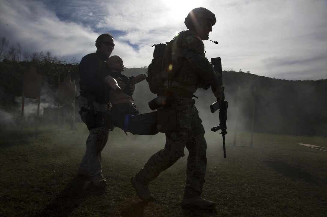 U.S. Army Staff Sgt. Justin Morelli, from the 982nd Combat Camera Company (Airborne), East Point, Ga., right, and a first responder from Florida evacuate a simulated casualty to a higher echelon of care after administering tactical field care when they are no longer under hostile fire during a Tactical Combat Casualty Care (TCCC) training exercise during a two-day certification held at OK Gun Corral Club, Okeechobee, Fla., Jan. 30, 2016. TCCC is designed for non-medical military personnel and includes first responder skills appropriate for soldiers. Available medical equipment is limited to that carried by each soldier and the medic. The course introduces evidence-based, life-saving techniques and strategies for providing the best trauma care on the battlefield. (U.S. Army photo by Spc. Tracy McKithern/Released)