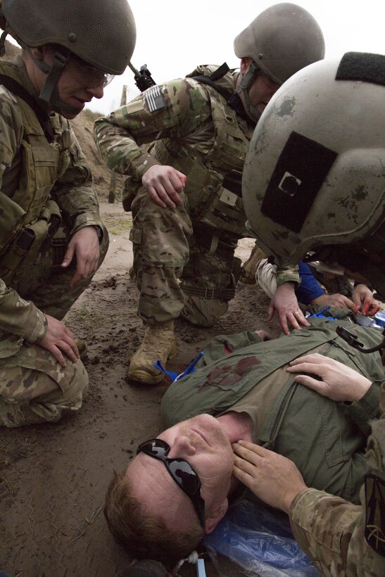 Soldiers from the 982nd Combat Camera Company (Airborne), East Point, Ga., provide combat lifesaving measures as a secondary mission, as their primary (combat) mission allows, during a Tactical Combat Casualty Care (TCCC) training exercise during a two-day certification held at OK Gun Corral Club, Okeechobee, Fla., Jan. 30, 2016. The combat lifesaver is trained to provide immediate care that can save a casualty’s life, such as stopping severe bleeding, administering intravenous fluids to control shock and performing needle chest decompression for a casualty with tension pneumothorax. TCCC introduces evidence-based, life-saving techniques and strategies for providing the best trauma care on the battlefield. (U.S. Army photo by Spc. Tracy McKithern/Released)
