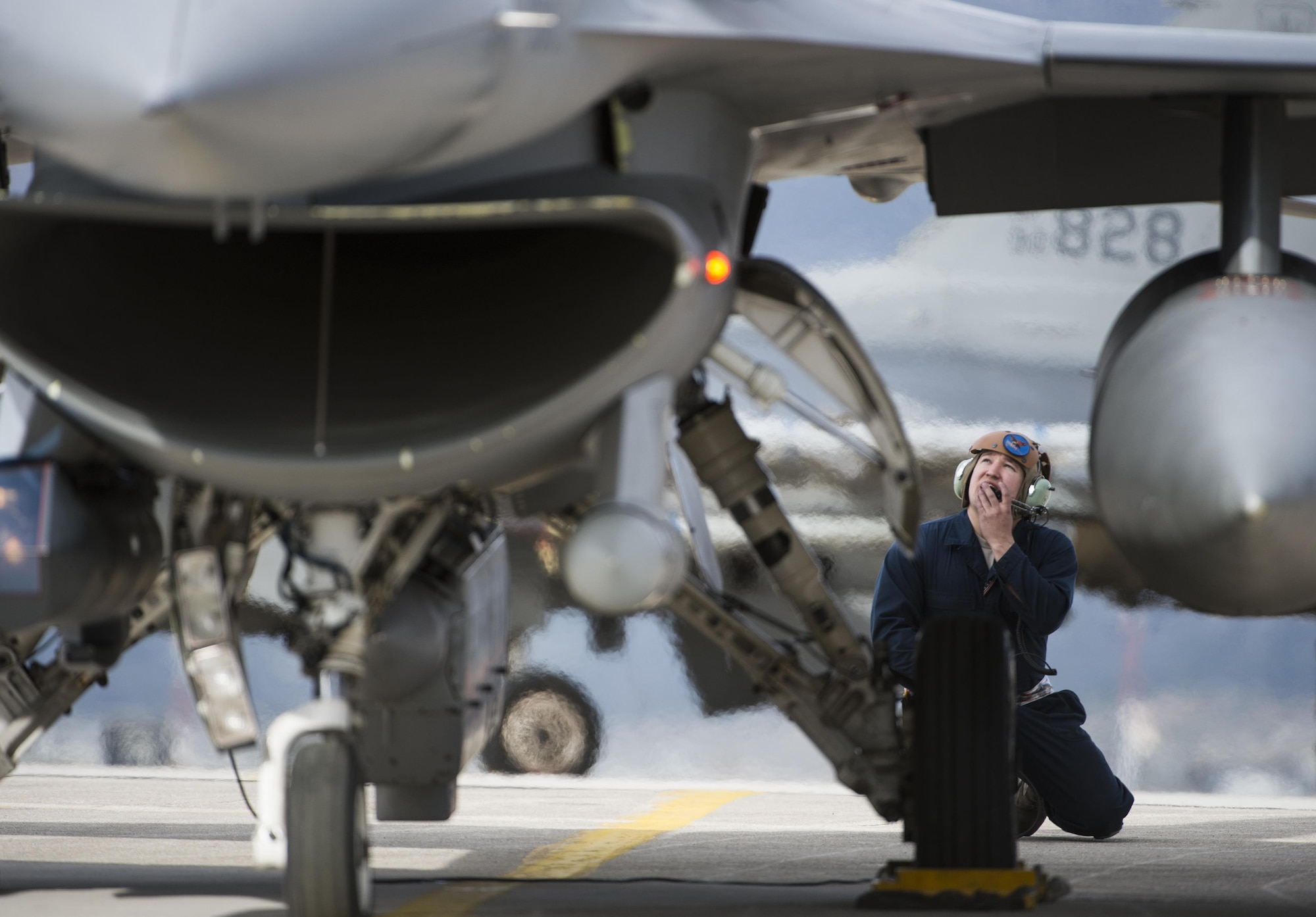 Staff Sgt. Ryan Anderson, a crew chief assigned to the 480th Expeditionary Fighter Squadron, performs preflight checks while communicating with a F-16 Fighting Falcon pilot before departure from the flightline at Souda Bay, Greece, Jan. 27. 2016. Anderson, along with 300 personnel from Spangdahlem Air Base, Germany, were participating in the flying training deployment between the Hellenic and U.S. air forces at Souda Bay from Jan. 22 to Feb. 15, 2016. (U.S. Air Force photo/Staff Sgt. Christopher Ruano)