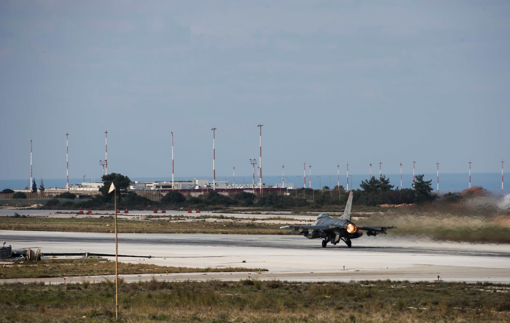 A U.S. Air Force F-16 Fighting Falcon fighter aircraft pilot launches his jet during a flying training deployment on the runway at Souda Bay, Greece, Jan. 27, 2016.  The training included more than 15 aircraft launches a day as part of the training between the U.S. and Hellenic air forces. (U.S. Air Force photo by Staff Sgt. Christopher Ruano/Released)