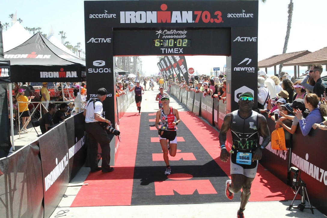 Marine Corps Staff Sgt. Kenneth Bell, right, finishes the 2015 Ironman 70.3 SuperFrog triathlon event in Coronado, Calif., Sept. 27, 2015. Bell, a helicopter mechanic with Headquarters Co., I Marine Expeditionary Force Headquarters Group, has participated in more than 25 major endurance training competitions. Courtesy Photo