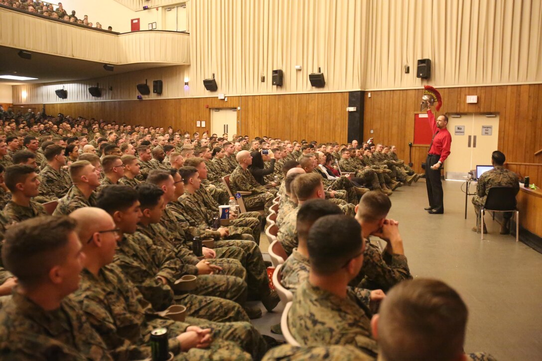 Motivational speaker Todd Parisi holds up his Spartan helmet for a war cry from Combat Logistics Regiment 25 at Camp Lejeune, N.C., Jan. 28, 2016. Parisi had promised a young girl battling leukemia that he would help keep her motivation high by recording a room full of Marines cheering for her. (U.S. Marine Corps photo by LCpl. Miranda Faughn/Released)