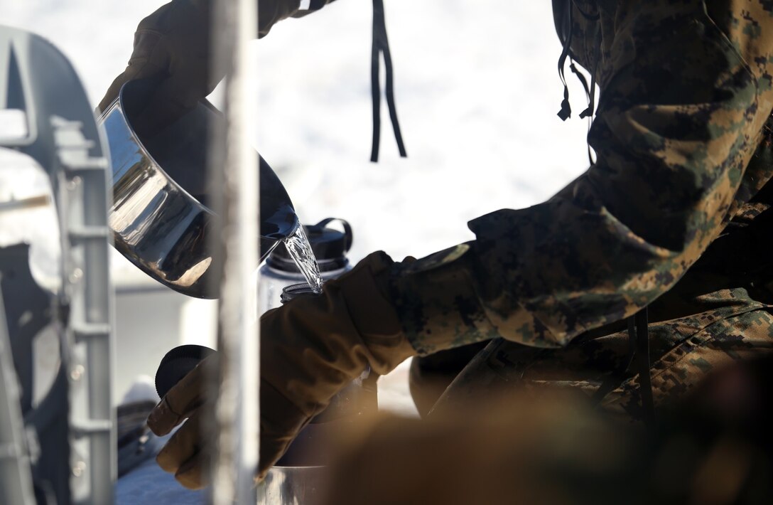 A Marine with Combat Logistics Battalion 252 pours purified water into a bottle in the mountains of Bridgeport, Calif,. during Mountain Exercise 1-16, a cold weather training exercise, on Jan. 12, 2016. The training is a prerequisite for a large, multi-national exercise called Cold Response 16 that will take place in Norway, March of this year. Cold Response will challenge 12 NATO allies’ and partners’ abilities to work together and respond in the case of a crisis. (U.S. Marine Corps photo by Lance Cpl. Brianna Gaudi/released)