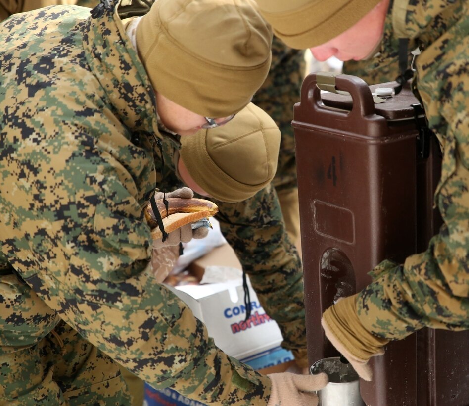 Marines with Combat Logistics Battalion 252 receive food and hot broth in the mountains of Bridgeport, Calif., during Mountain Exercise 1-16, a cold weather training exercise, on Jan. 14, 2016. The training is a prerequisite for a large, multi-national exercise called Cold Response 16 that will take place in Norway, March of this year. Cold Response will challenge 12 NATO allies’ and partners’ abilities to work together and respond in the case of a crisis. (U.S. Marine Corps photo by Lance Cpl. Brianna Gaudi/released)