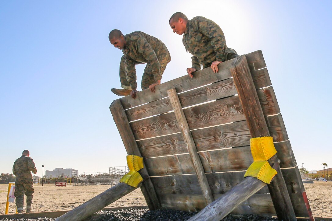 Marine Corps recruits climb over a wall at Marine Corps Recruit Depot San Diego, Jan. 25, 2016. Drill instructors monitored the recruits’ progress to make sure they were maneuvering over the obstacle correctly. Marine Corps photo by Lance Cpl. Angelica I. Annastas
