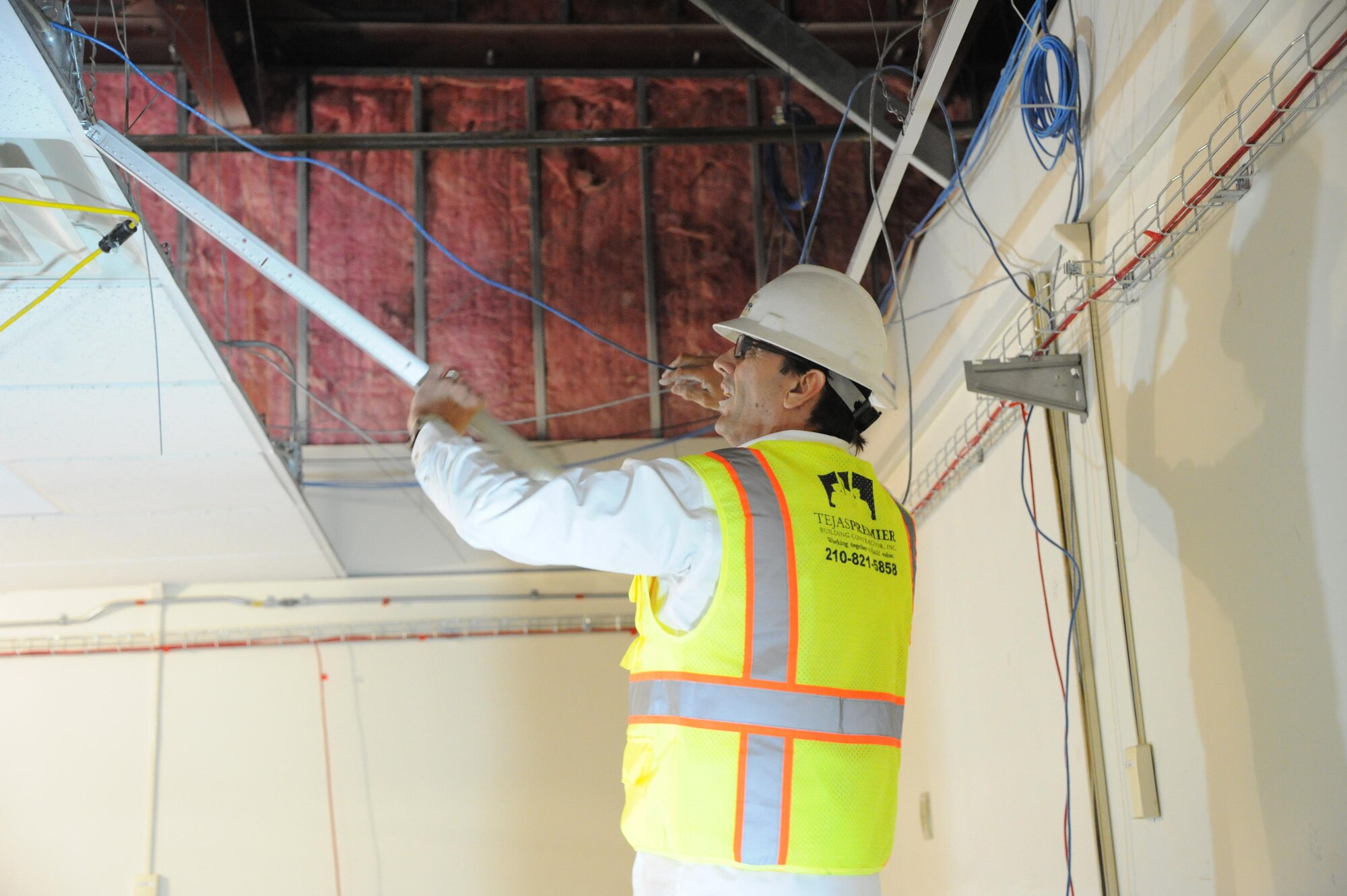 John Sweeney, Tejas Premier Building Contractor Inc., removes ceiling tiles at the 558th Flying Training Squadron during renovation work to the unit’s classrooms Feb. 1 at Joint Base San Antonio-Randolph.  The renovations, part of an effort to increase undergraduate remotely-piloted aircraft pilot training class sizes meant to double the number of graduates beginning in fiscal year 2017, include additional simulator rooms, plus additional classroom and office space.   