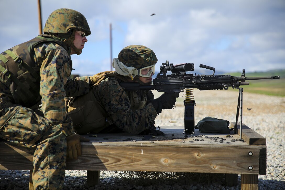 Marine Corps Lance Cpl. Ethan Evans, left, instructs Lance Cpl. Jacob Levy on firing an M249B light machine gun during comprehensive live-fire training on Camp Roberts, Calif., Jan 23, 2016. The Marines are assigned to the 6th Air Naval Gunfire Liaison Company. Marine Corps photo by Cpl. Tiffany Edwards