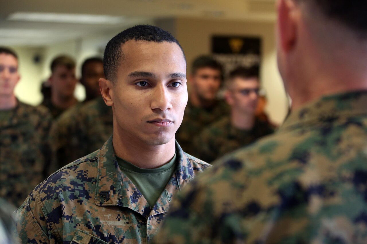 Cpl. Justin McDaniel accepts the Navy and Marine Corps Achievement Medal during an award ceremony at Marine Corps Air Station Cherry Point, N.C., Dec. 3, 2015. McDaniel was presented the award for his quick and precise problem solving skills that led to the safe landing of an AV-8B Harrier that had experienced navigational equipment failure. His actions on Dec. 1, 2015, were the product of McDaniel’s extensive training and well-earned confidence in his own skills as an air traffic controller. (U.S. Marine Corps Photo By Cpl. N.W. Huertas/Released) 

