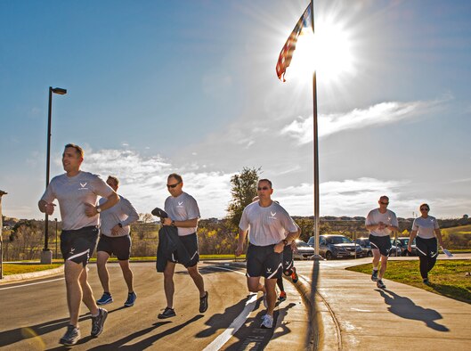 Commanders from the 433rd Airlift Wing begin their 3-mile run from wing headquarters building Jan. 27, 2016 at Joint Base San Antonio-Lackland, Texas. The commanders took part in a three-day conference focused on enhancing communication between commanders, and building unit cohesion within the wing.  (U.S. Air Force photo by Benjamin Faske) (released)