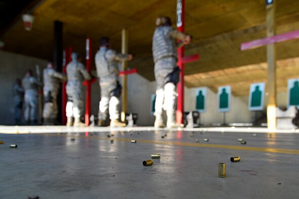 Team Dover Airmen qualify on M9 pistols while training to be certified unit marshals Jan. 6, 2016, at the Combat Arms Training and Maintenance facility on Dover Air Force Base, Del. Unit marshals  went through more than 60 hours of training in use of force, weapon fundamentals, defensive shooting, active shooter response and actions on combat (U.S. Air Force photo/Senior Airman William Johnson)