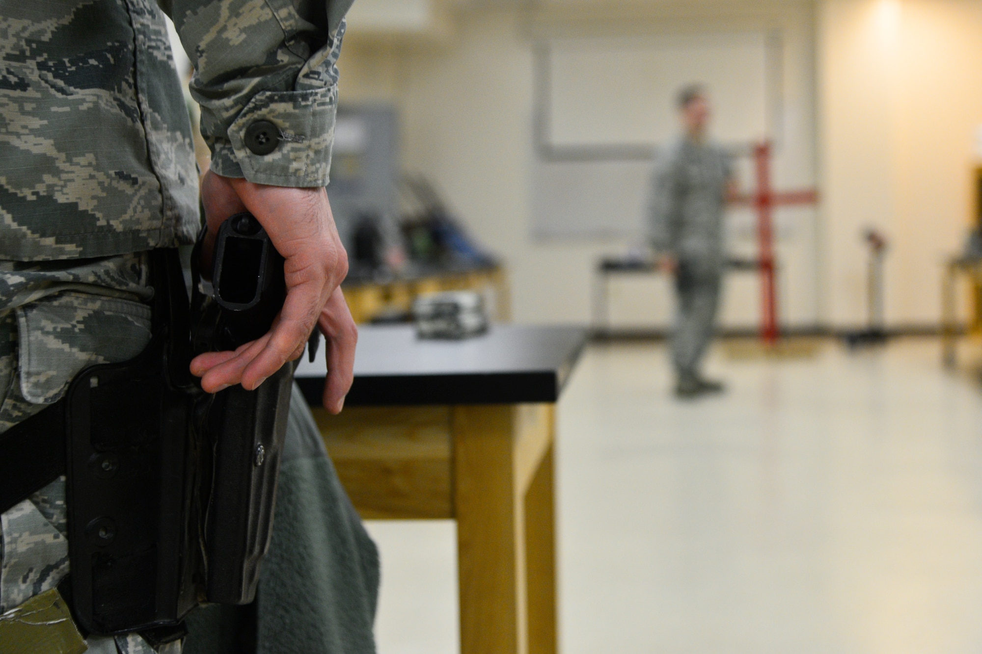 Staff Sgt. Eliezer Ribeiro, 436thLogistics Readiness Squadron quality assurance evaluator, practices drawing his M9 pistol during a weapons fundamentals training course while training to become a unit marshal Jan. 6, 2016, at the Combat Arms Training and Maintenance facility on Dover Air Force Base, Del. unit marshals will have the option to carry from a drop down leg holster or hip holster. (U.S. Air Force photo/Senior Airman William Johnson)