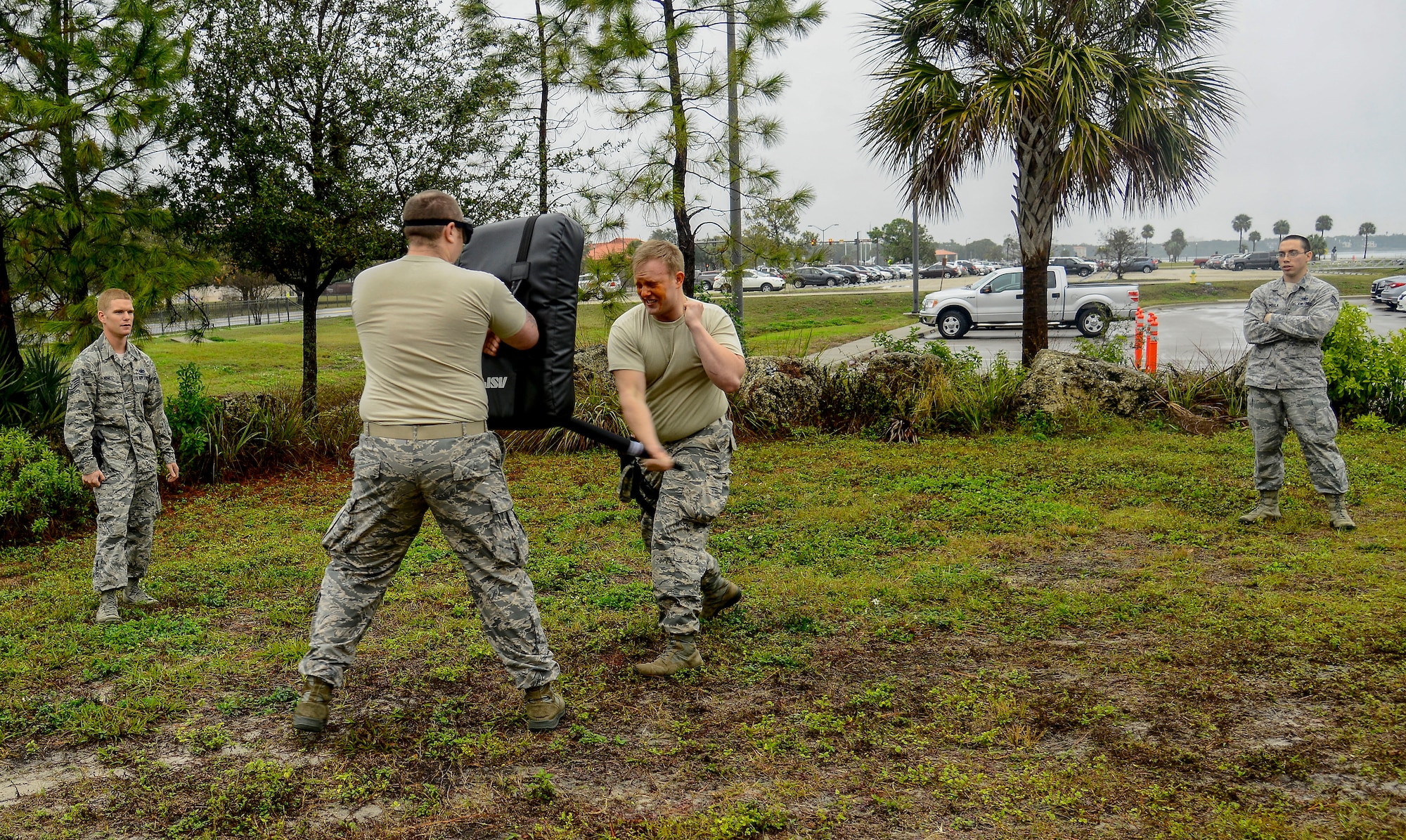 Senior Airman Beau Bartulis, a military working dog handler with the 6th Security Forces Squadron uses baton strikes to fend off an attacker after being sprayed with oleoresin capsicum (OC) during a Less Than Lethal Certification Course at MacDill Air Force Base, Fla., Jan. 28, 2016. This certification is required for a security forces member to carry and use OC spray in a use of force situation. (U.S. Air Force photo by Staff Sgt. Melanie Hutto)
