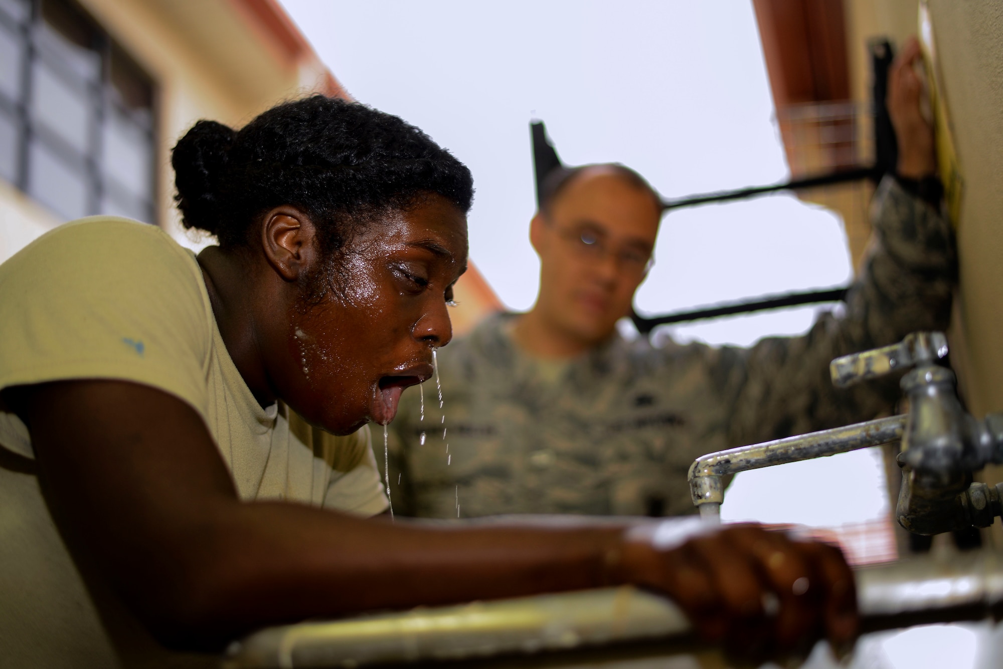 Senior Airman Barbara Walker-Johnson, an entry controller with the 6th Security Forces Squadron catches her breath after washing off the oleoresin capsicum during a Less Than Lethal Certification Course at MacDill Air Force Base, Fla., Jan. 28, 2016. The obstacle course consisted of fending off an adversary utilizing authorized baton striking techniques, accurately identifying a training weapon held by a suspect, then challenging and apprehending that suspect. (U.S. Air Force photo by Staff Sgt. Melanie Hutto)
