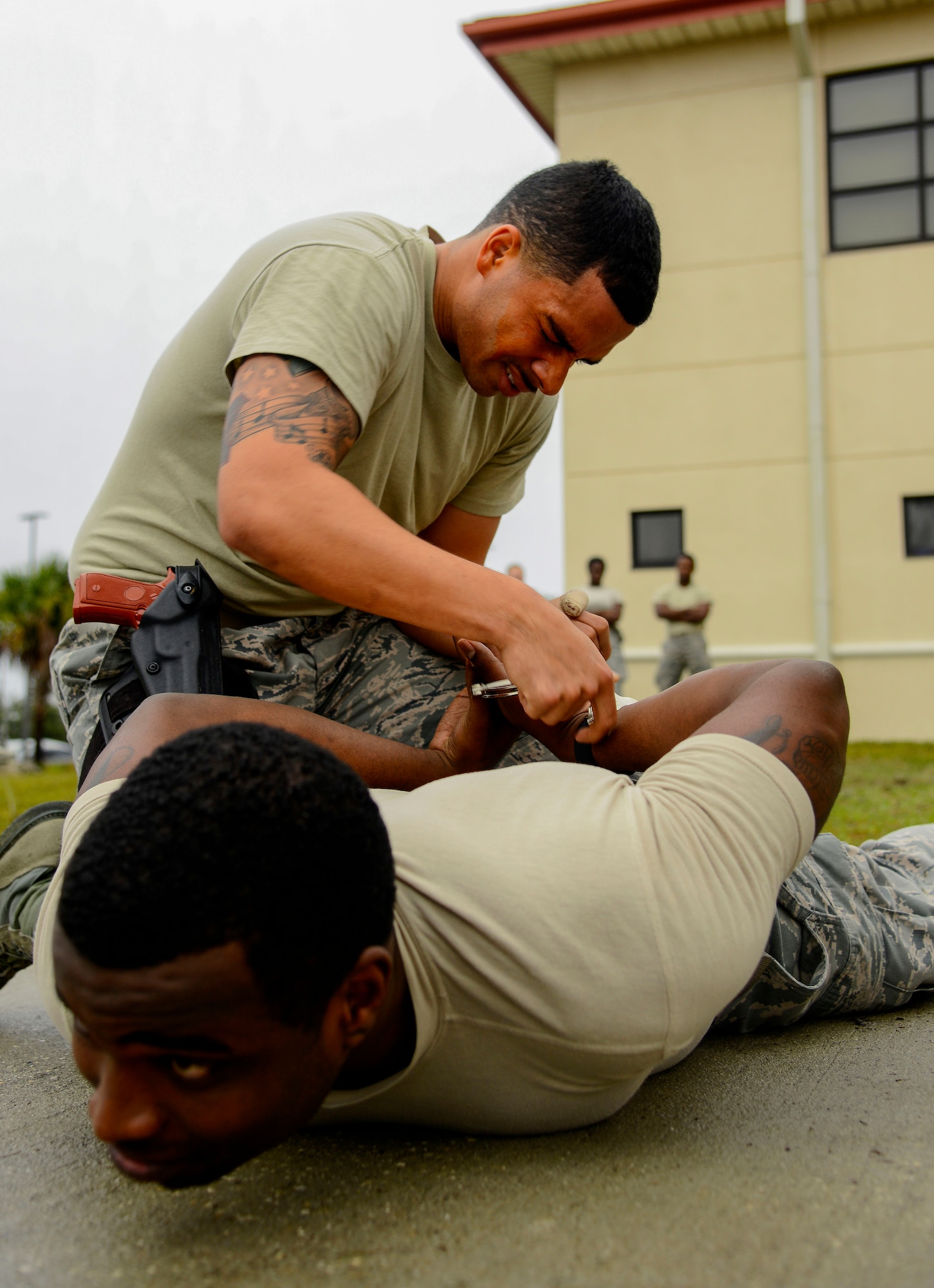 Staff Sgt. Landell Brown, an installation patrolman assigned to the 6th Security Forces Squadron, apprehends a “suspect” after being sprayed with oleoresin capsicum (OC) during a Less Than Lethal Certification Course at MacDill Air Force Base, Fla., Jan. 28, 2016. This certification is required for a security forces member to carry and use OC spray in a use of force situation. (U.S. Air Force photo by Staff Sgt. Melanie Hutto) 
