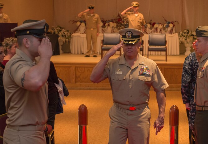 Navy Captain Charles Phillip, Navy Munitions Command Atlanta Unit Charleston commander, salutes as he departs from CWO3 Jason Roach’s commissioning ceremony at the Red Bank Club on Joint Base Charleston – Naval Weapons Station, S.C., on Jan. 29, 2016. Roach was commissioned to CWO3 from MCPO. (U.S. Air Force photo/Airman 1st Class Thomas T. Charlton)