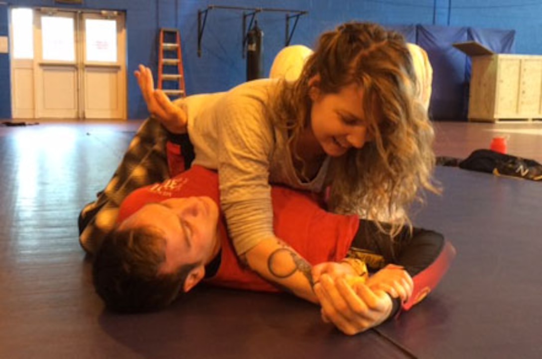 Emma Prior, a U.K. local resident and class participant, right, uses a Kimura to submit U.S. Air Force Staff Sgt. Saul Grosshuesch, 100th Maintenance Squadron unit deployment manager, left, during a self-defense class Jan. 23, 2016, in the Northside Fitness Center on RAF Mildenhall, England. The 100th Air Refueling Wing Sexual Assault Prevention and Response office is coordinating new classes open to active duty and civilian personnel and their family members. (Courtesy photo/Released)