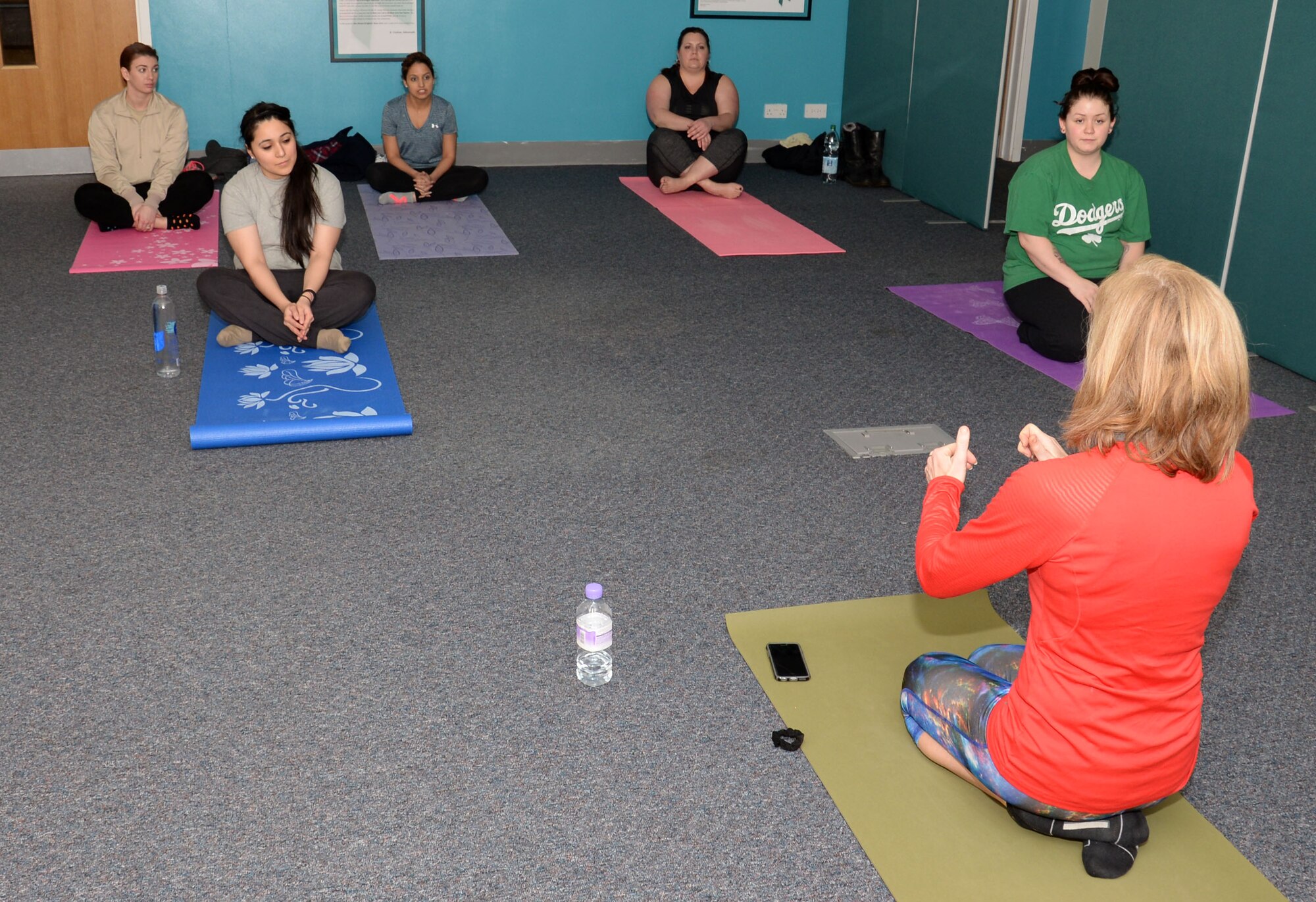 Dana Howard, far right, a yoga instructor, briefs the group during a yoga class hosted by the 100th Air Refueling Wing Sexual Assault Prevention and Response office Jan. 21, 2016, on RAF Mildenhall, England. Howard hopes to encourage more people on base to take up the practice of yoga to help them deal with stress. (U.S. Air Force photo by Gina Randall/Released)