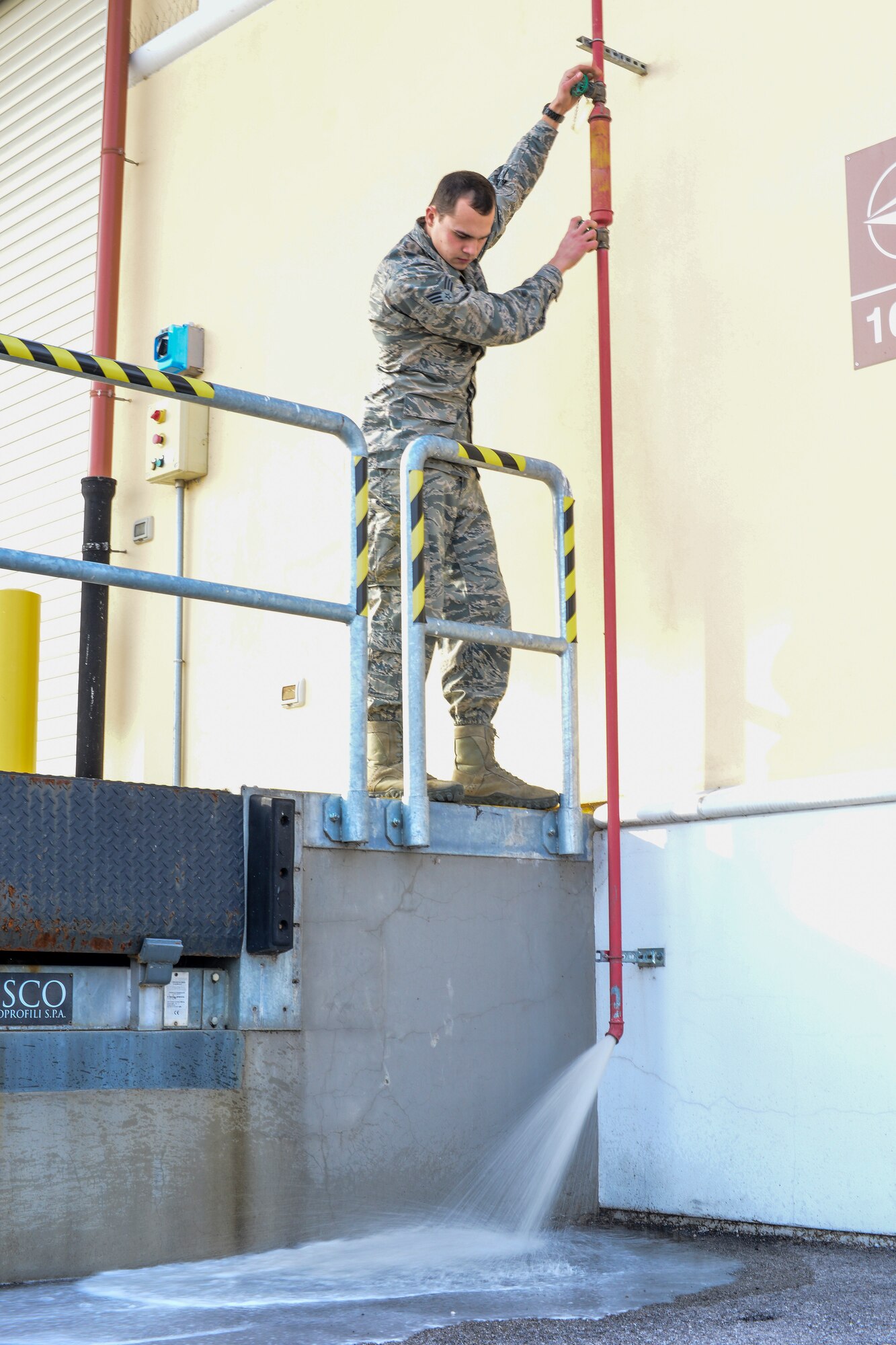 Senior Airman Jacob Neeb, 31st Civil Engineer Squadron water and fuels systems maintenance journeyman, relieves pressure to cycle water through fire suppression system pipes at Aviano Air Base, Italy, Jan. 26, 2016. When a fire is detected and the system is activated, pressurized air is replaced with water to extinguish the flames. (U.S Air Force photo by Airman 1st Class Cory W. Bush/Released)