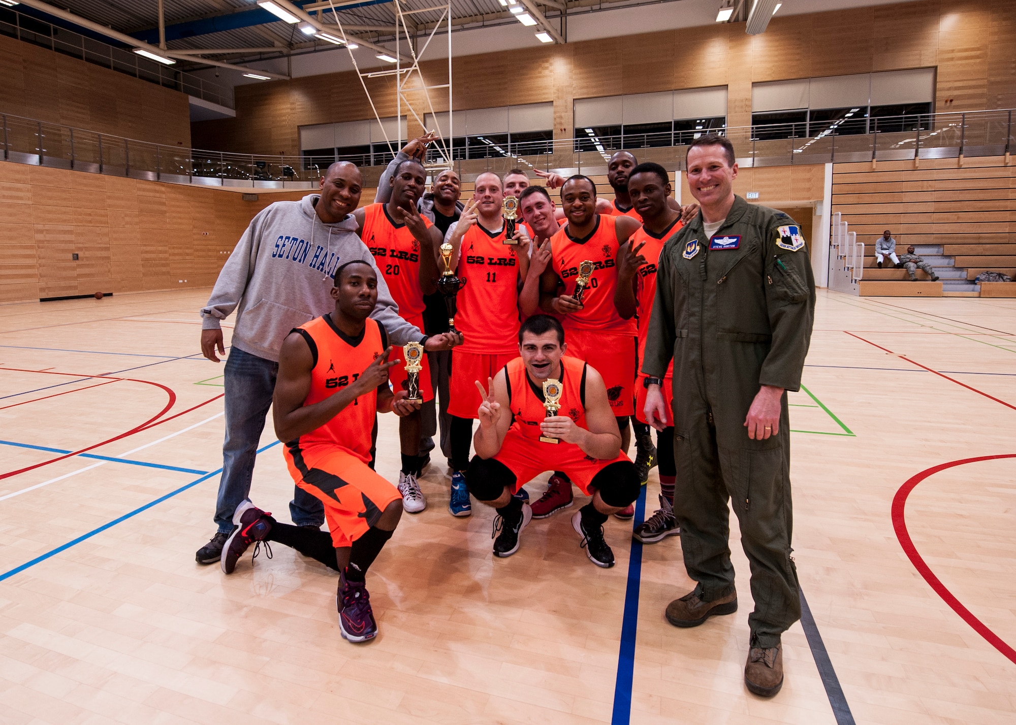Leadership from the 52nd Fighter Wing pose for a photo with the 52nd Logistics Readiness Squadron intramural basketball team after winning the Intramural Basketball Championship game inside the George Price Gymnasium Jan. 28, 2016, at Spangdahlem Air Base, Germany. The game came down to a last second missed basket and ended with the 52nd LRS intramural basketball team winning the game with a final score of 54-52. (U.S. Air Force photo by Senior Airman Rusty Frank/Released)