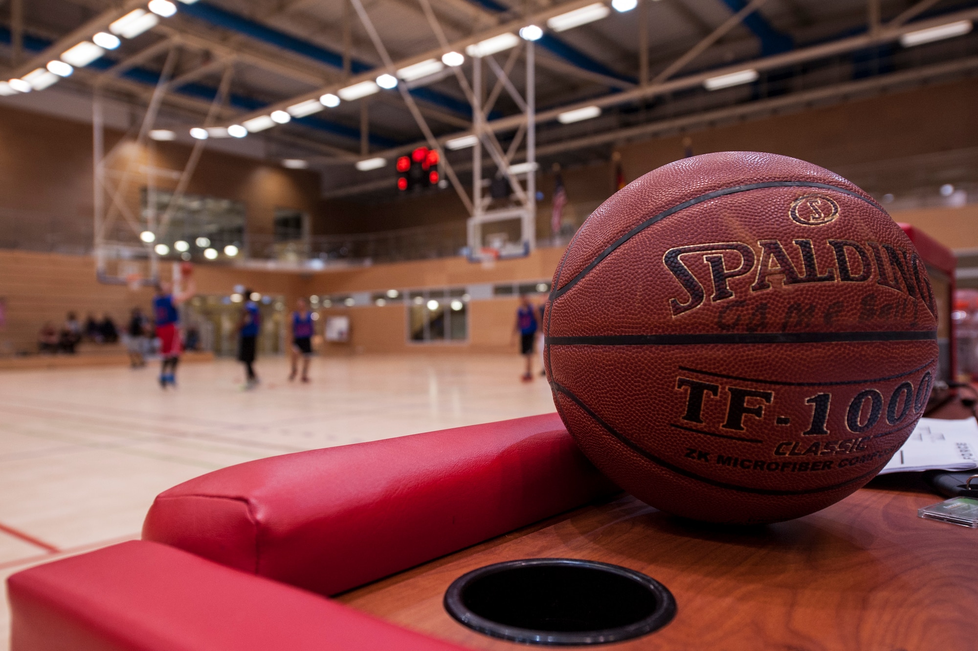 A basketball rests on a table during half time of the Intramural Basketball Championship game inside the George Price Gymnasium Jan. 28, 2016 at Spangdahlem Air Base, Germany. After the game ended, the 52nd Logistics Readiness Squadron finished undefeated this season. (U.S. Air Force photo by Senior Airman Rusty Frank/Released)
