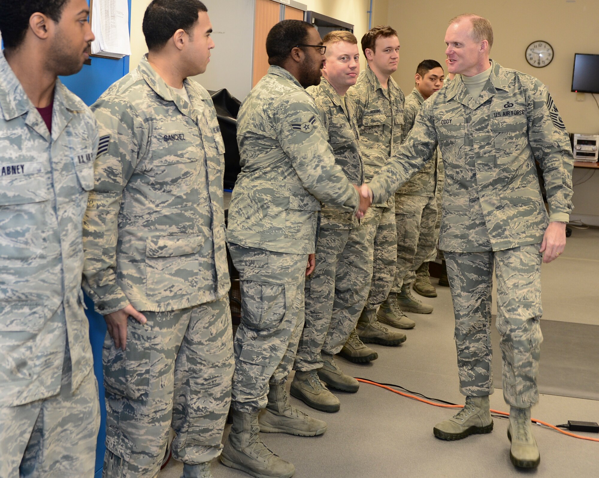 Chief Master Sgt. of the Air Force James Cody greets Airmen from the aircrew flight equipment flights during his tour of Royal Air Force Lakenheath, England, January 28, 2016. He spoke with Airmen throughout the wing and expressed his appreciation for the way the Liberty Wing executes the mission and strives for excellence. (U.S. Air Force photo by Senior Airman Dawn M. Weber/Released)