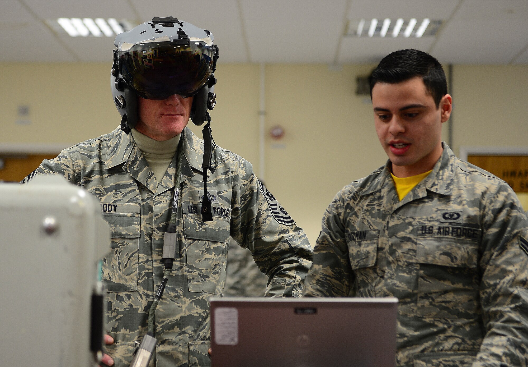 Chief Master Sgt. of the Air Force James Cody is given a briefing on the pilot’s helmets used at Royal Force Lakenheath, England by Airman 1st Class Christopher Guzman, 48th Operations Support Squadron aircrew flight equipment apprentice, January 29, 2016. He spoke with Airmen throughout the wing and expressed his appreciation for the way the Liberty Wing executes the mission and strives for excellence. (U.S. Air Force photo by Senior Airman Dawn M. Weber/Released)