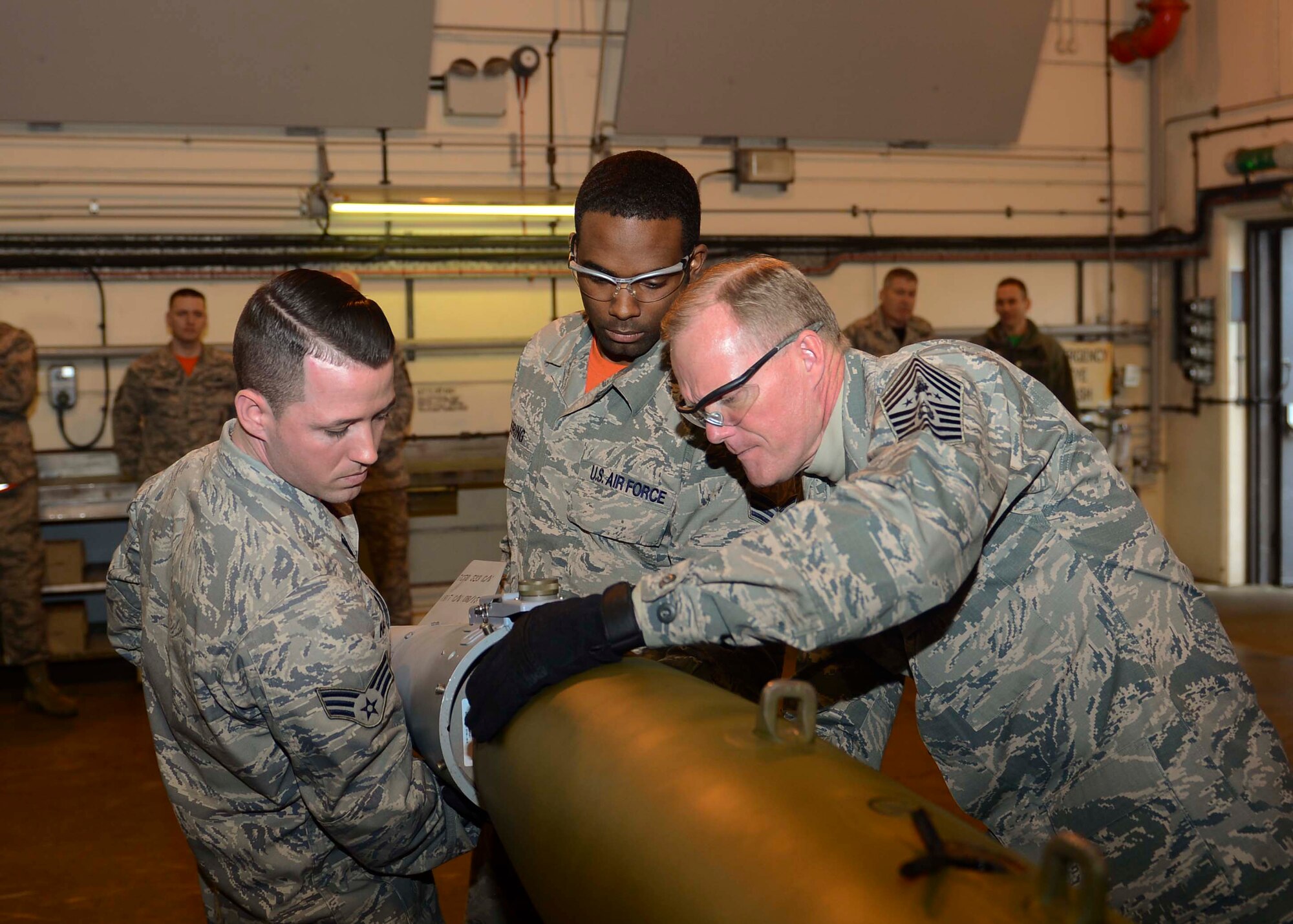 Chief Master Sgt. of the Air Force James Cody took a tour of the munitions shop at Royal Air Force Lakenheath, England, Jan. 29, 2016. Airmen of the 48th Munitions Squadron showed the CMSAF first-hand how they build guided-bomb units. (U.S. Air Force photo by Senior Airman Nigel Sandridge/Released)