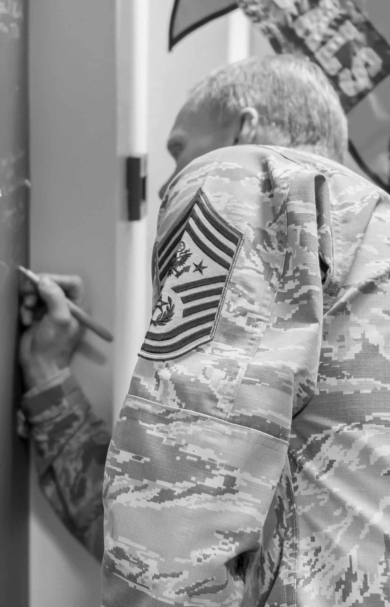 Chief Master Sgt. of the Air Force James Cody signs the historic wall at Mathies Airman Leadership School on Royal Air Force Feltwell, England, Jan. 29, 2016. Cody visited the Liberty Wing to discuss a variety of topics and to express his appreciation for the way Liberty Airmen execute the mission and strive for excellence. (U.S. Air Force photo/Senior Airman Trevor T. McBride/Released)