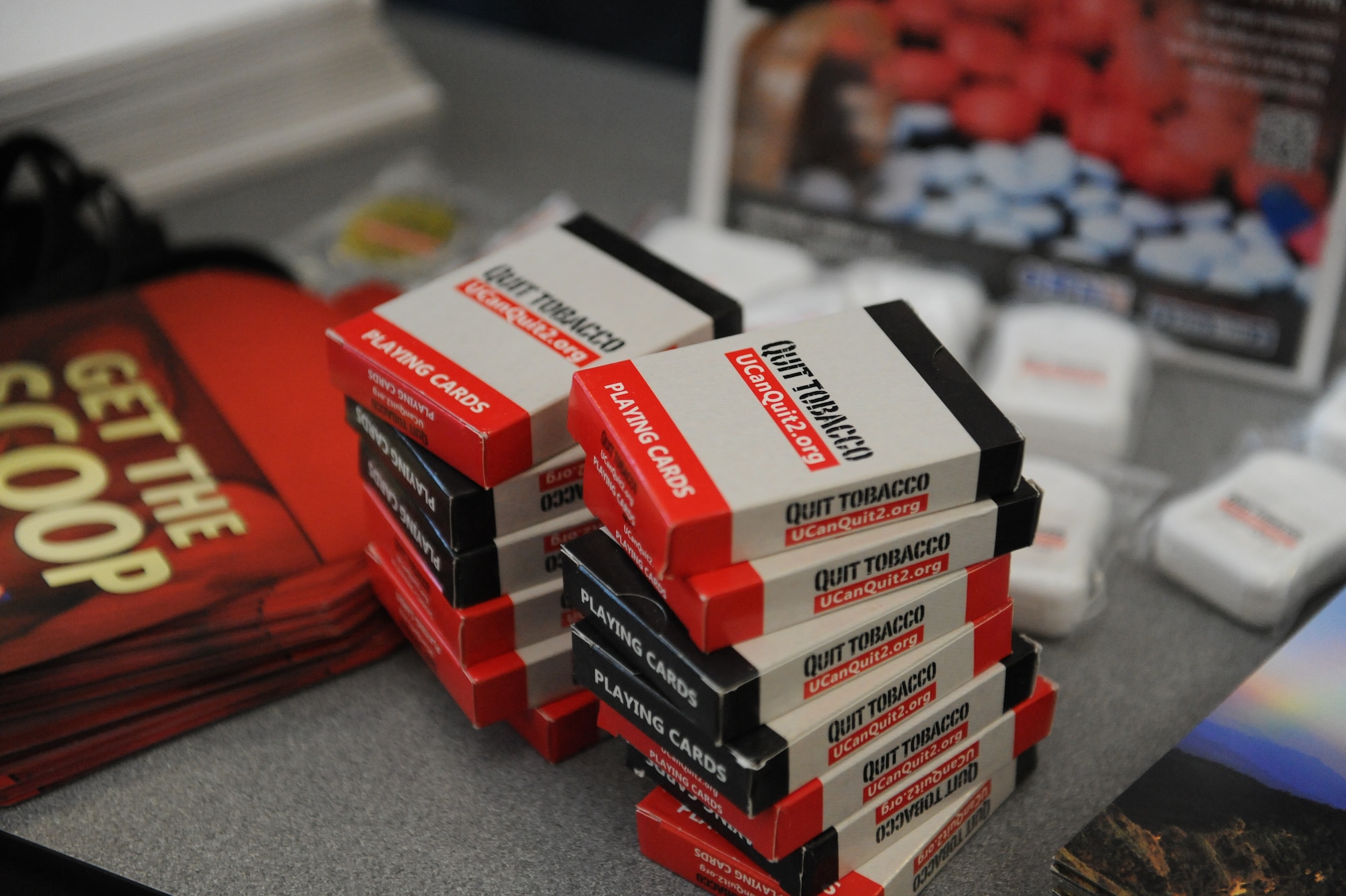Quit tobacco playing cards, with other various items, sit on a table during an information expo held by the fitness center at Whiteman Air Force Base, Mo., Jan. 29, 2016. Support personnel from the education office, physical therapy, mental health/ADAPT, the Chaplain Corps, health promotion director and the fitness center provided guidance to individuals to help reach their 2016 goals. (U.S. Air Force photo by Tech. Sgt. Miguel Lara III) 