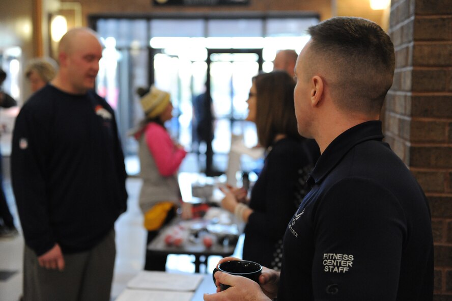 Fitness Center staff members and support representatives brief service members and families during an information expo at Whiteman Air Force Base, Mo., Jan. 29, 2016. The information expo was held at the base fitness center with representatives from support agencies such as the education center and the Chaplain Corps available to provide guidance to help individuals reach their 2016 goals. (U.S. Air Force photo by Tech. Sgt. Miguel Lara III)