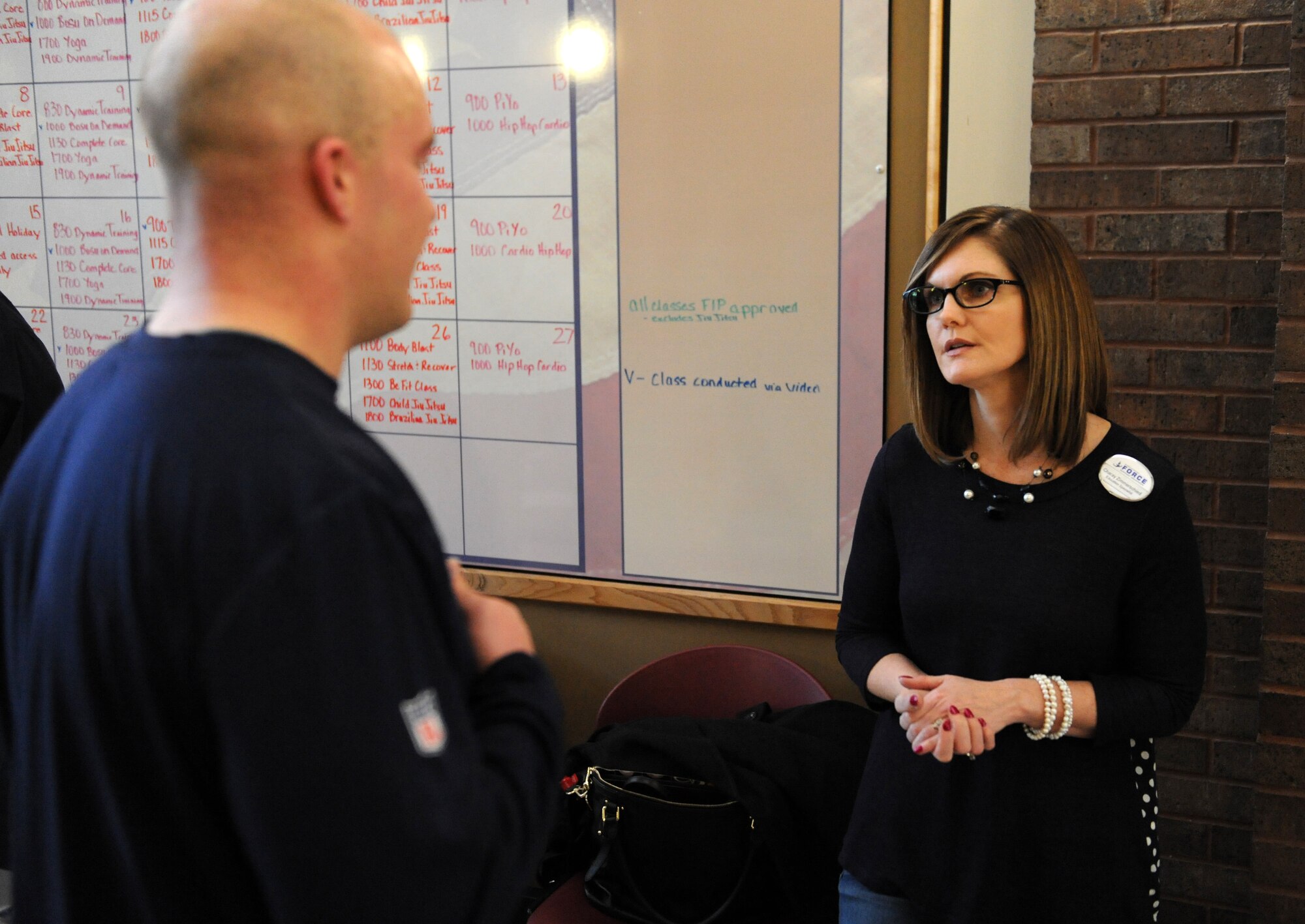Charay Zimmerschied, a 509th Force Support Squadron education specialist, briefs a member of Team Whiteman during an information expo at Whiteman Air Force Base, Mo., Jan. 29, 2016. The information expo provided individuals with guidance from support agencies, such as the education center, to help members achieve their goals for the year. (U.S. Air Force photo by Tech. Sgt. Miguel Lara III)
