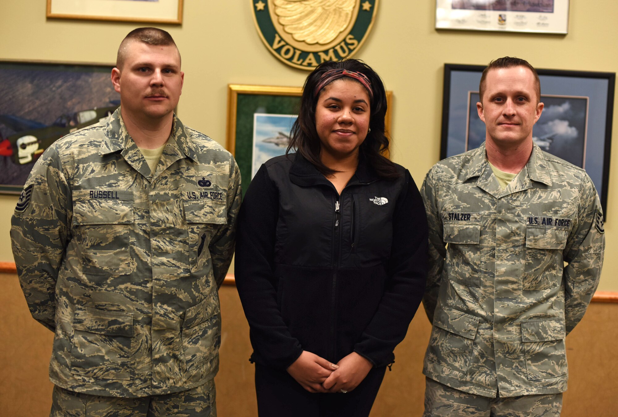 From left to right, Tech. Sgt. Shaun Russell 341st Security Support Squadron NCO in charge of resources and logistics, Denise Willis, mother of Aryanna Willis and military dependent, and Staff Sgt. Joe Stalzer, 819th REDHORSE pavement and equipment apprentice, pose for a photograph after an interview with local media at the Grizzly Bend at Malmstrom Air Force Base, Mont., Jan. 29, 2016. Denise Willis’s daughter Aryanna had suffered a stroke while on the way back from the emergency room the day Russell and Stalzer offered their medical expertise, which saved the young girl’s life. (U.S. Air Force photo/Airman Collin Schmidt)