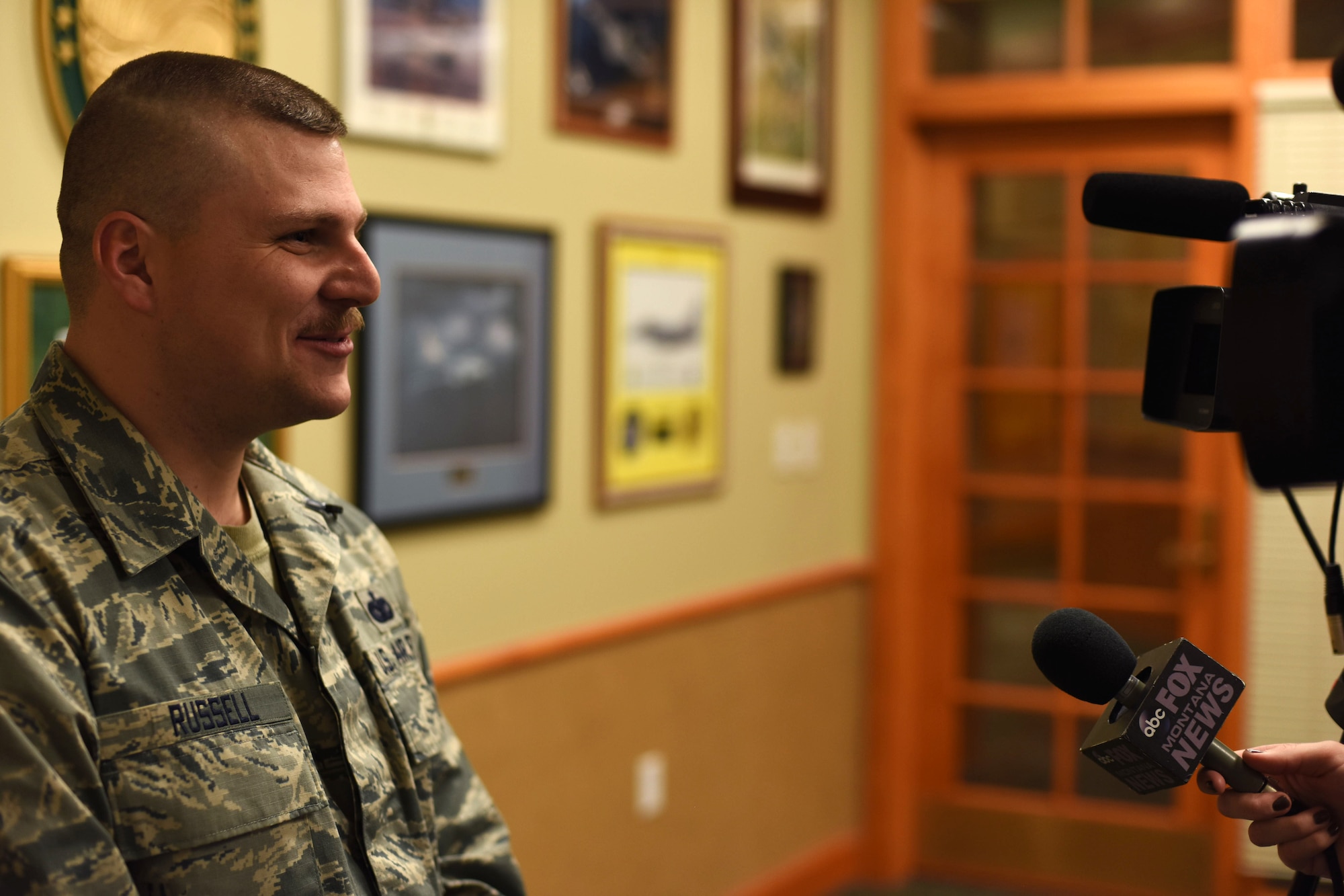 Tech. Sgt. Shaun Russell, 341st Security Support Squadron NCO in charge of resources and logistics, speaks with media during an interview at the Grizzly Bend at Malmstrom Air Force Base, Mont., Jan. 29, 2016. During the interview, Russell gave his account of the actions he took the day he assisted in saving the life of a little girl. (U.S. Air Force photo/Airman Collin Schmidt) 