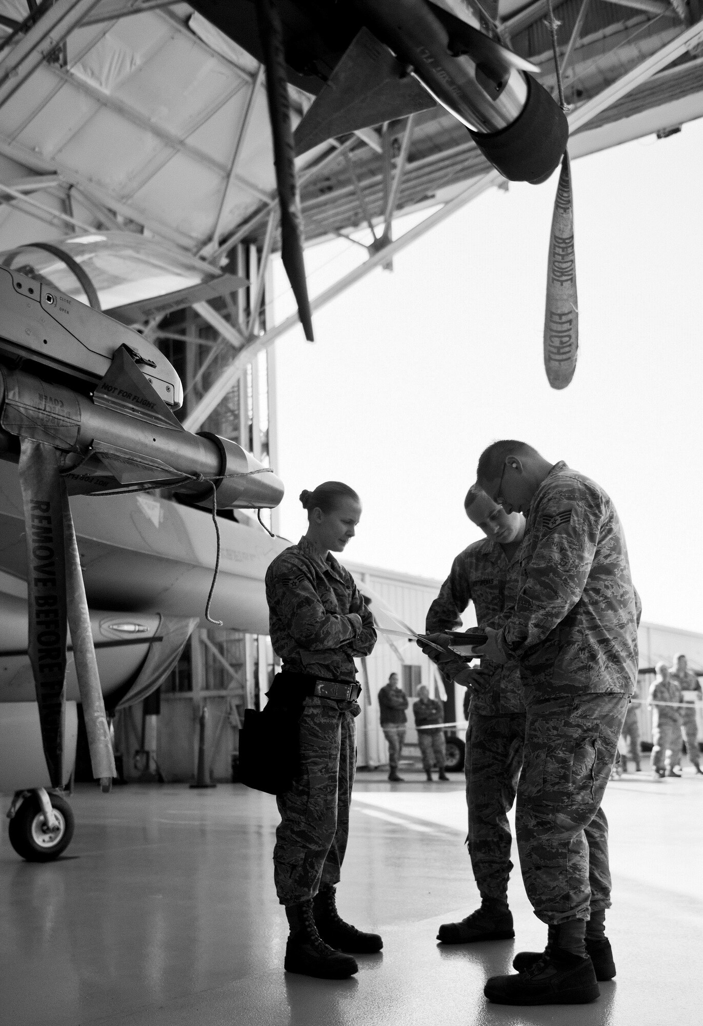 A 96th Aircraft Maintenance Squadron Blue team verifies their F-16 Fighting Falcon checklist during the Loadcrew of the Year competition at Eglin Air Force Base, Fla., Jan. 29.  Two F-16 loadcrews battled two F-15 Eagle loadcrews for the best time and fewest mistakes while loading three missiles to their respective aircraft.  The winners will be revealed at the annual 96th Maintenance Group banquet in March.  (U.S. Air Force photo/Samuel King Jr.)