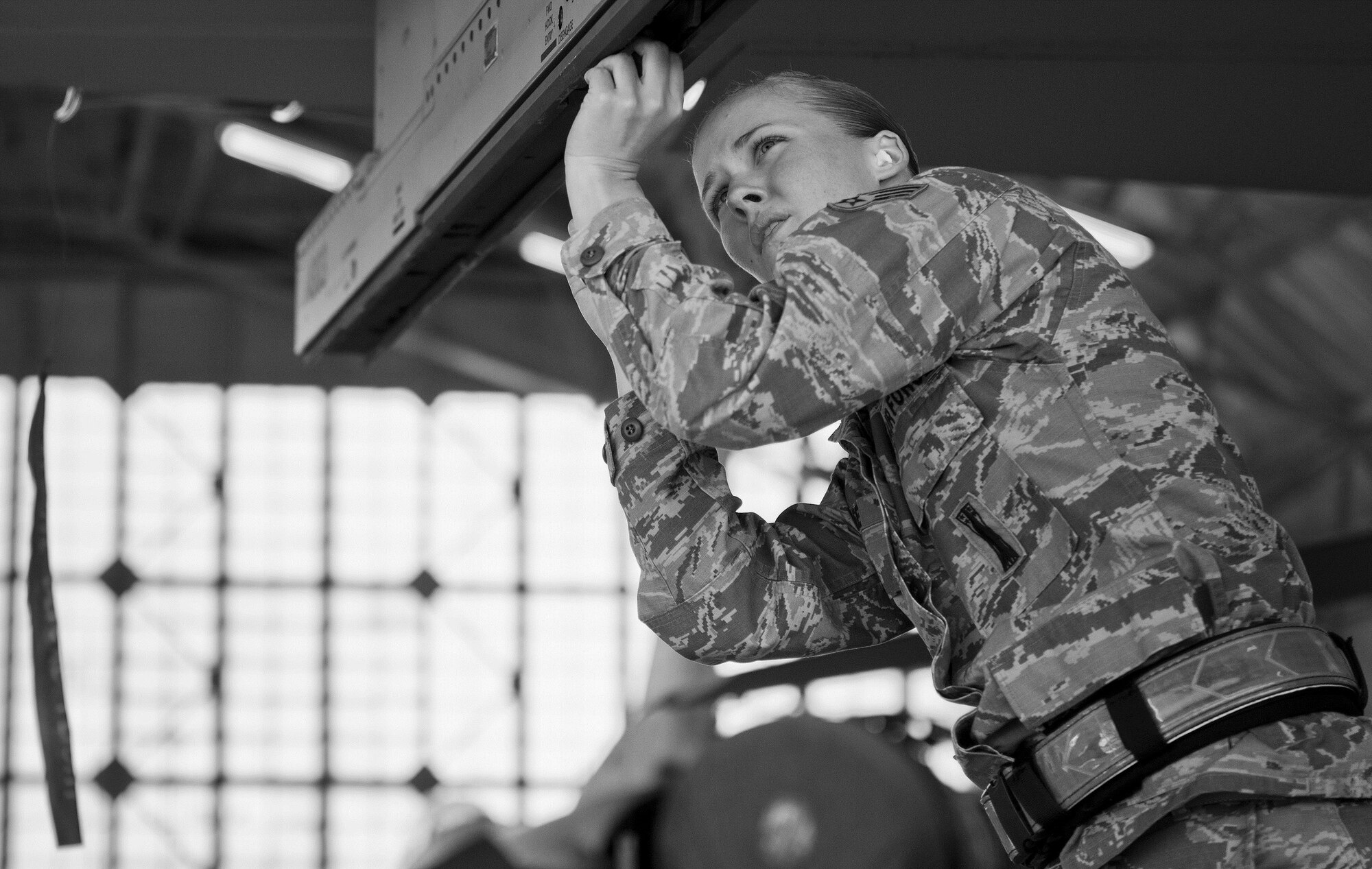 Senior Airman Kyndle Lee, 96th Aircraft Maintenance Squadron Blue, prepares the F-16 Fighting Falcon’s missile rack for loading during the Loadcrew of the Year competition at Eglin Air Force Base, Fla., Jan. 29.  Two F-16 Fighting Falcon loadcrews battled two F-15 Eagle loadcrews for the best time and fewest mistakes while loading three missiles to their respective aircraft.  The winners will be revealed at the annual 96th Maintenance Group banquet in March.  (U.S. Air Force photo/Samuel King Jr.)