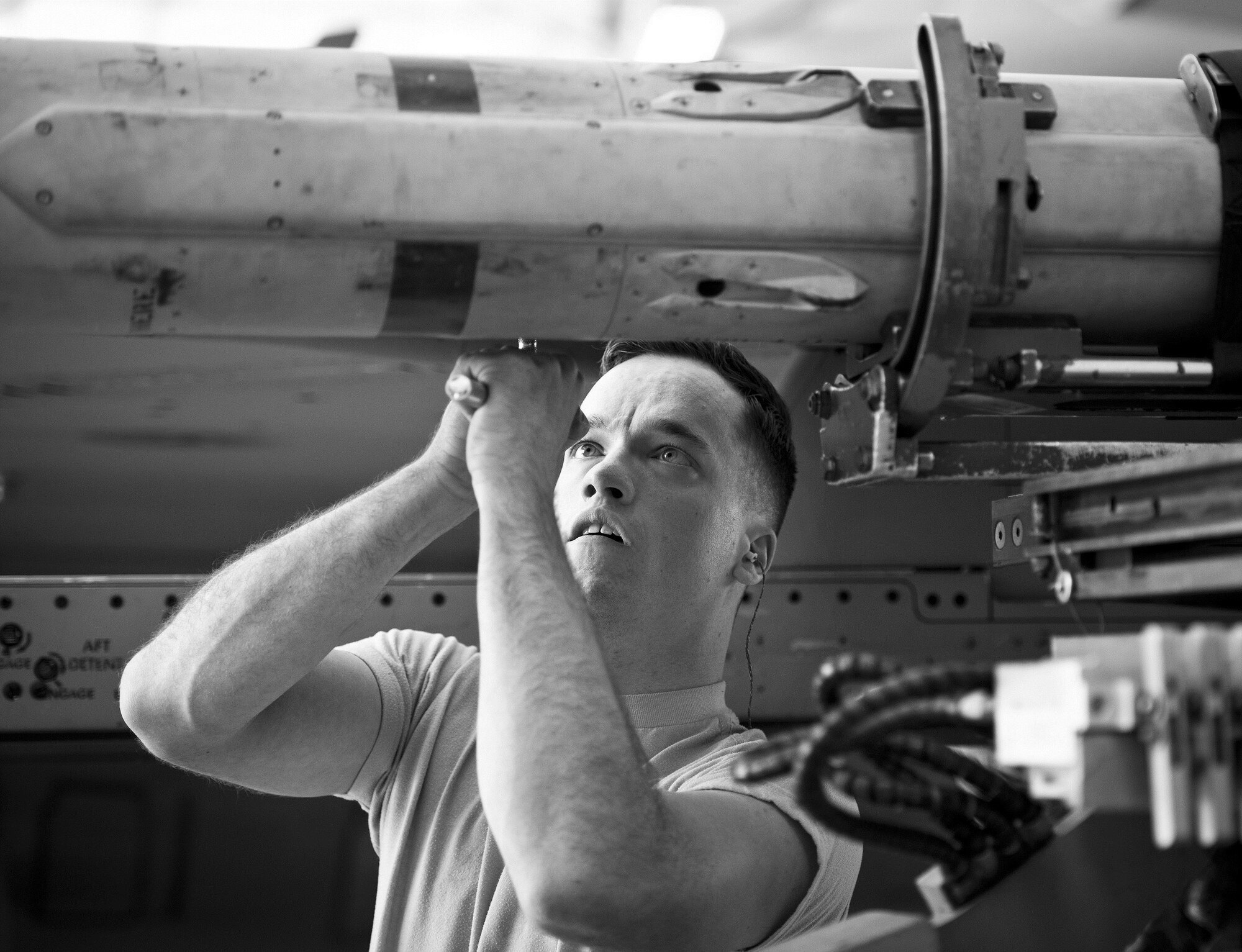 Airman 1st Class William Walters, 96th Aircraft Maintenance Squadron Blue, secures an AIM-120 to an F-16 Fighting Falcon during the Loadcrew of the Year competition at Eglin Air Force Base, Fla., Jan. 29.  Two F-16 loadcrews battled two F-15 Eagle loadcrews for the best time and fewest mistakes while loading three missiles to their respective aircraft.  The winners will be revealed at the annual 96th Maintenance Group banquet in March.  (U.S. Air Force photo/Samuel King Jr.)