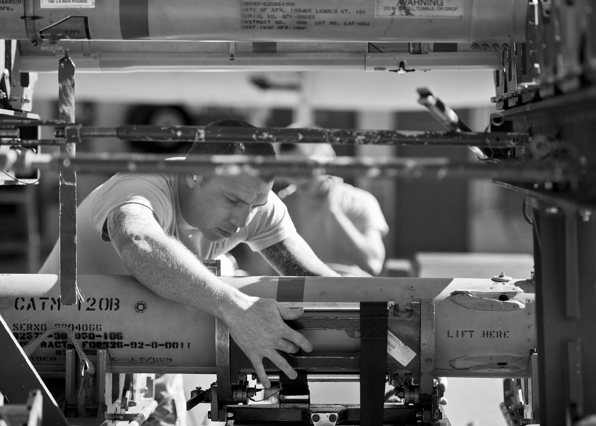 Staff Sgt. Jason Vermillion, 96th Aircraft Maintenance Squadron Blue, ensures an AIM-120 is secured to the bomb rack before moving it to an F-16 Fighting Falcon during the Loadcrew of the Year competition at Eglin Air Force Base, Fla., Jan. 29.  Two F-16 loadcrews battled two F-15 Eagle loadcrews for the best time and fewest mistakes while loading three missiles to their respective aircraft.  The winners will be revealed at the annual 96th Maintenance Group banquet in March.  (U.S. Air Force photo/Samuel King Jr.)