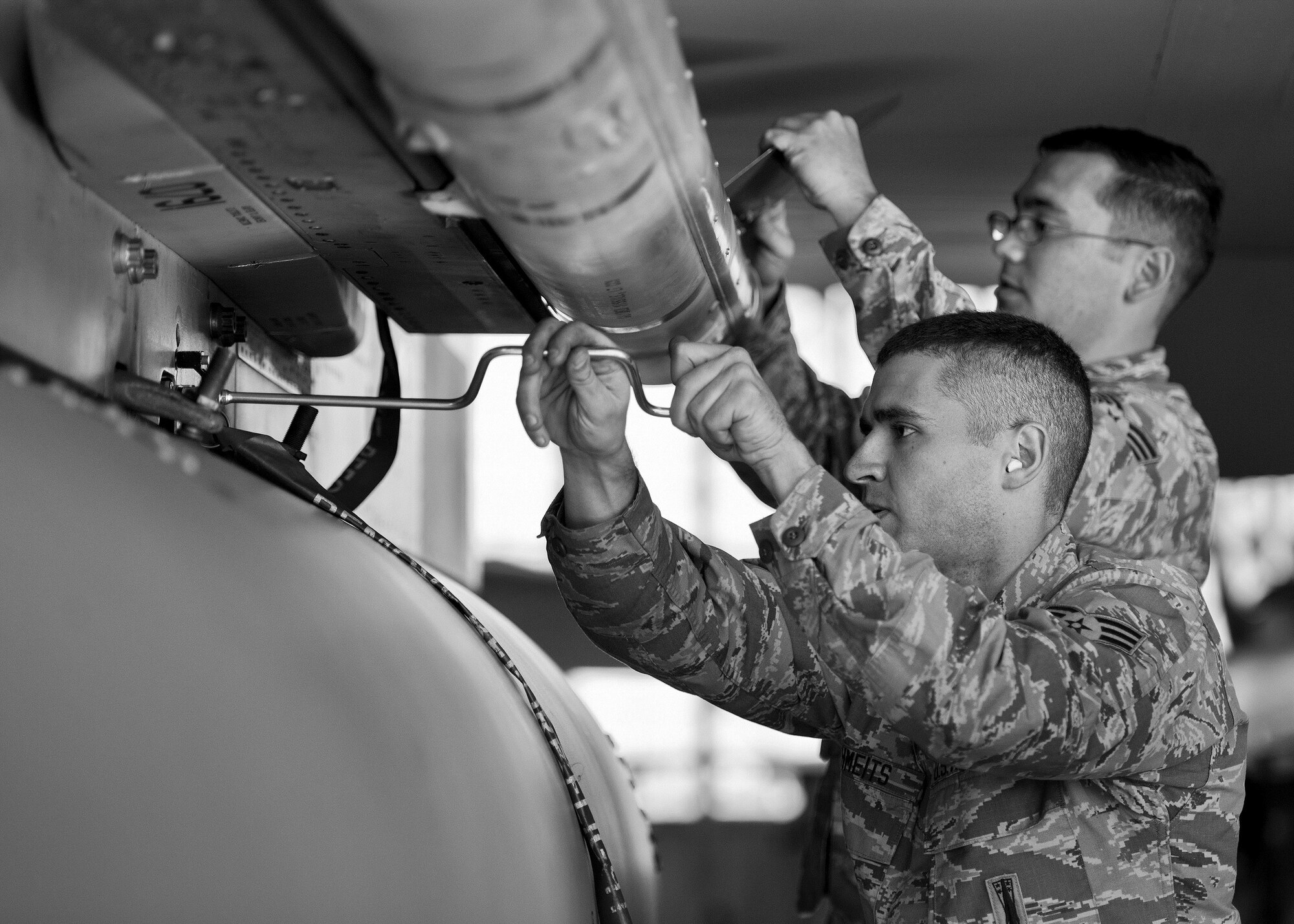 A 96th Aircraft Maintenance Squadron Red team secures an AIM-120 onto an F-15 Eagle during the Loadcrew of the Year competition at Eglin Air Force Base, Fla., Jan. 29.  Two F-15 loadcrews battled two F-16 Fighting Falcon loadcrews for the best time and fewest mistakes while loading three missiles to their respective aircraft.  The winners will be revealed at the annual 96th Maintenance Group banquet in March.  (U.S. Air Force photo/Samuel King Jr.)