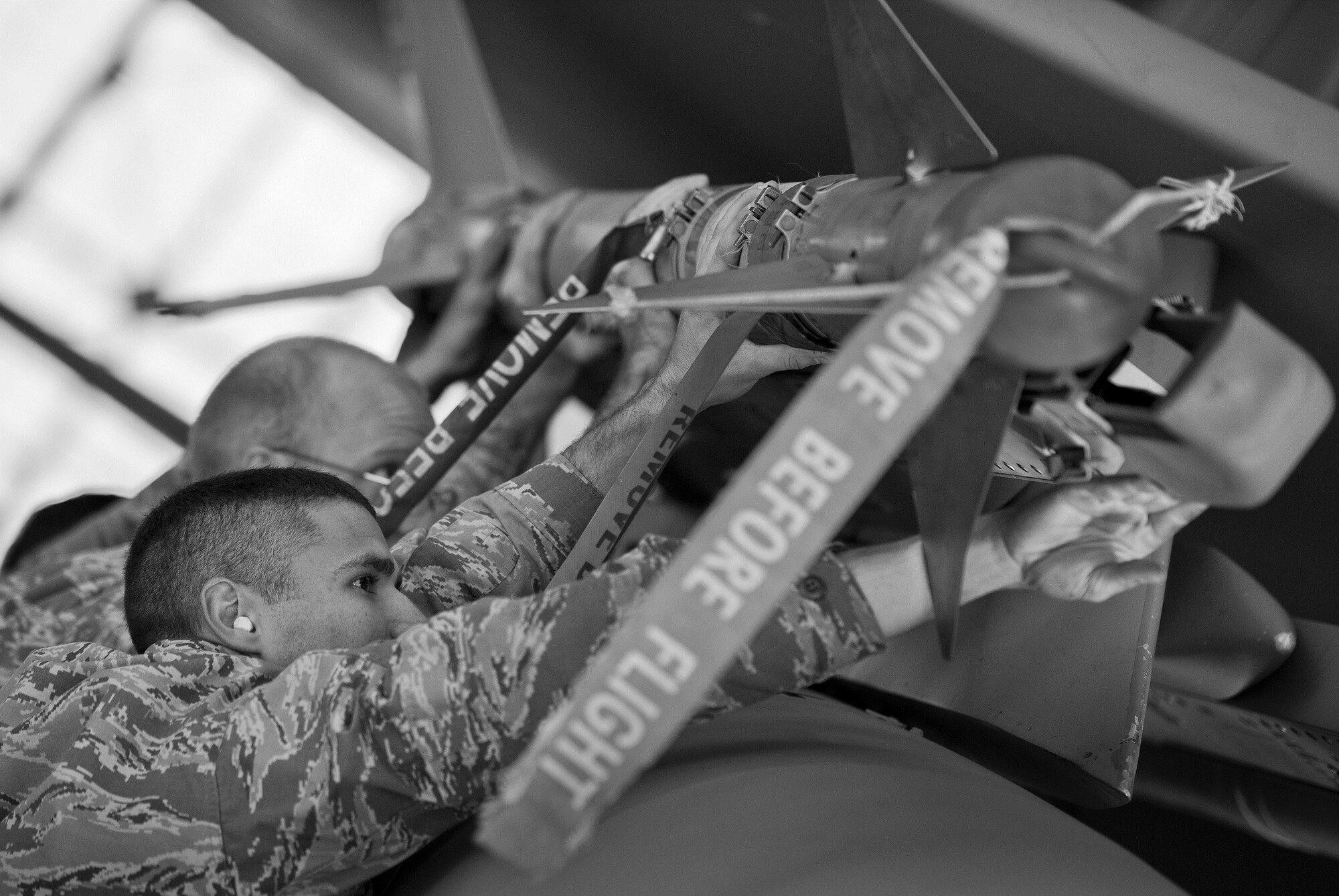 A 96th Aircraft Maintenance Squadron Red team lifts an AIM-9 onto an F-15 Eagle during the Loadcrew of the Year competition at Eglin Air Force Base, Fla., Jan. 29.  Two F-15 loadcrews battled two F-16 Fighting Falcon loadcrews for the best time and fewest mistakes while loading three missiles to their respective aircraft.  The winners will be revealed at the annual 96th Maintenance Group banquet in March.  (U.S. Air Force photo/Samuel King Jr.)