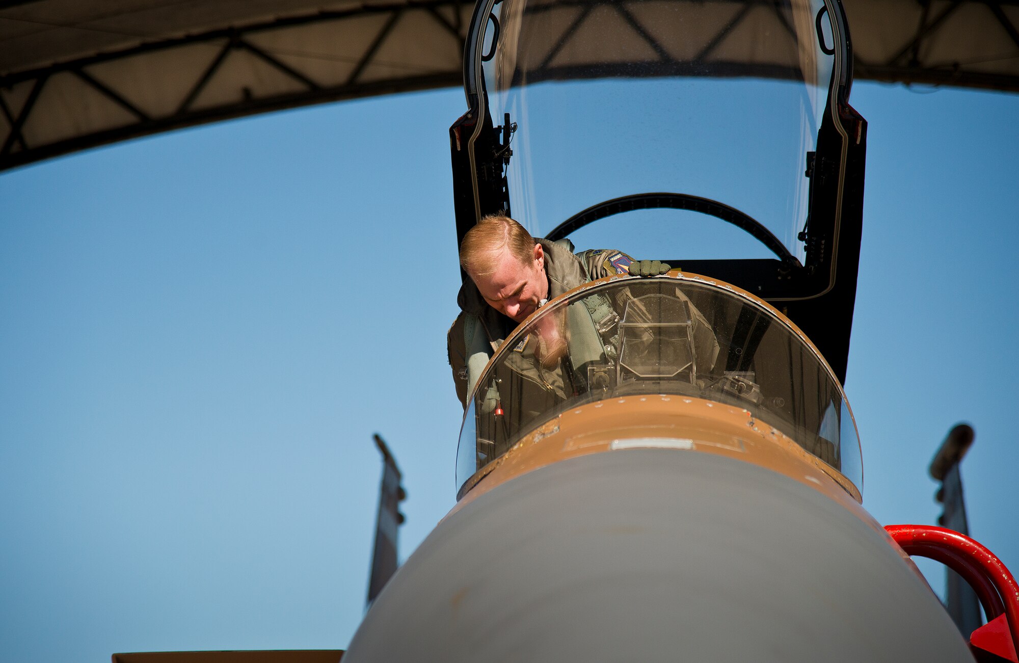Lt. Col. Matthew Berggren settles into the seat of his brown camouflage F-15 Eagle prior to a sortie Jan. 20 at Eglin Air Force Base, Fla. The camouflage 85th Test and Evaluation Squadron aircraft is the only one painted this way on the base. Its Jan. 20 sortie marked the last time it would fly with that paint scheme before being returned to the traditional gray. The F-15 was painted that way for its role as an aggressor aircraft in combat flight training exercises at Nellis Air Force Base, Nev. (U.S. Air Force photo/Samuel King Jr.)