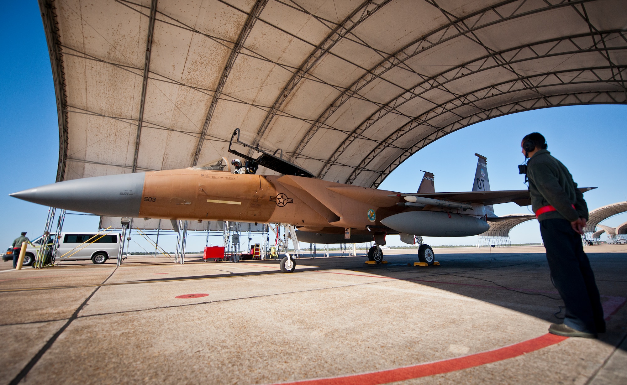 Preflight checks continue on the ground and in the cockpit of the brown camouflage F-15 Eagle prior to a sortie Jan. 20 at Eglin Air Force Base, Fla. The camouflage 85th Test and Evaluation Squadron aircraft is the only one painted this way on the base. Its Jan. 20 sortie marked the last time it would fly with that paint scheme before being returned to the traditional gray. The F-15 was painted that way for its role as an aggressor aircraft in combat flight training exercises at Nellis Air Force Base, Nev. (U.S. Air Force photo/Samuel King Jr.)