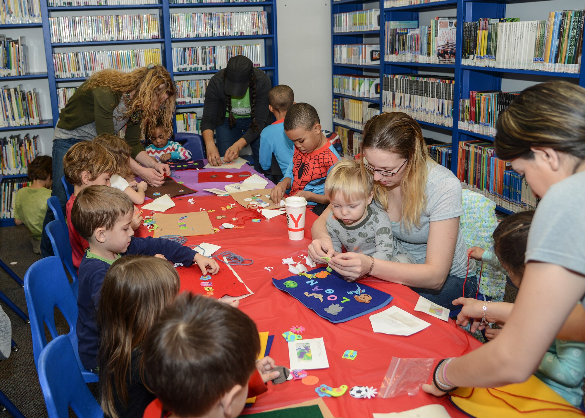 Children at the base library made pillows out of felt and stuffing “sewn together” with yarn, and decorated in foam stickers during Pajama Story Time Jan. 29. (U.S. Air Force photo by Rebecca Amber)